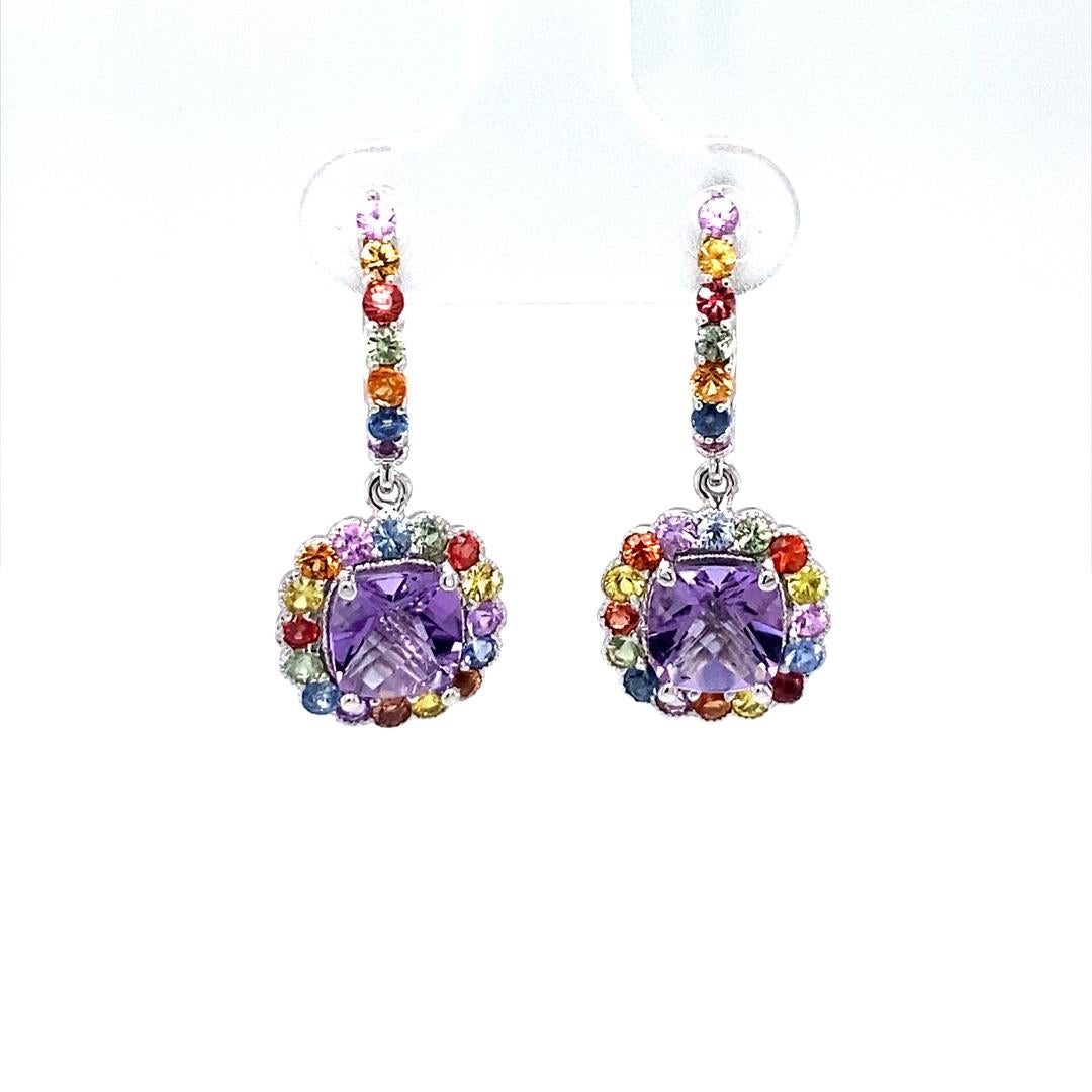 Amethyst, Multi-Colored Sapphire Drop Earrings! 

These cute and dainty Earrings have 2 Cushion Cut Amethysts that weigh 2.64 Carats and are embellished with 46 Round Cut Multi-Colored Sapphires that weigh 2.20 Carats. The Total Carat weight of the