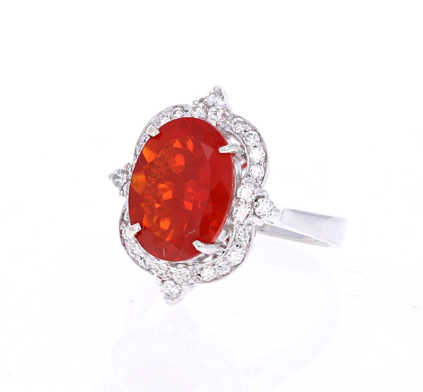 This gorgeous cocktail ring has a beautiful Red Oval Cut Fire Opal that weighs 4.31 carats and 28 Round Cut Diamonds that weigh 0.53 carats. The clarity and color of the diamonds are VS2-H.  The total carat weight of the ring is 4.84 carats. 

It is
