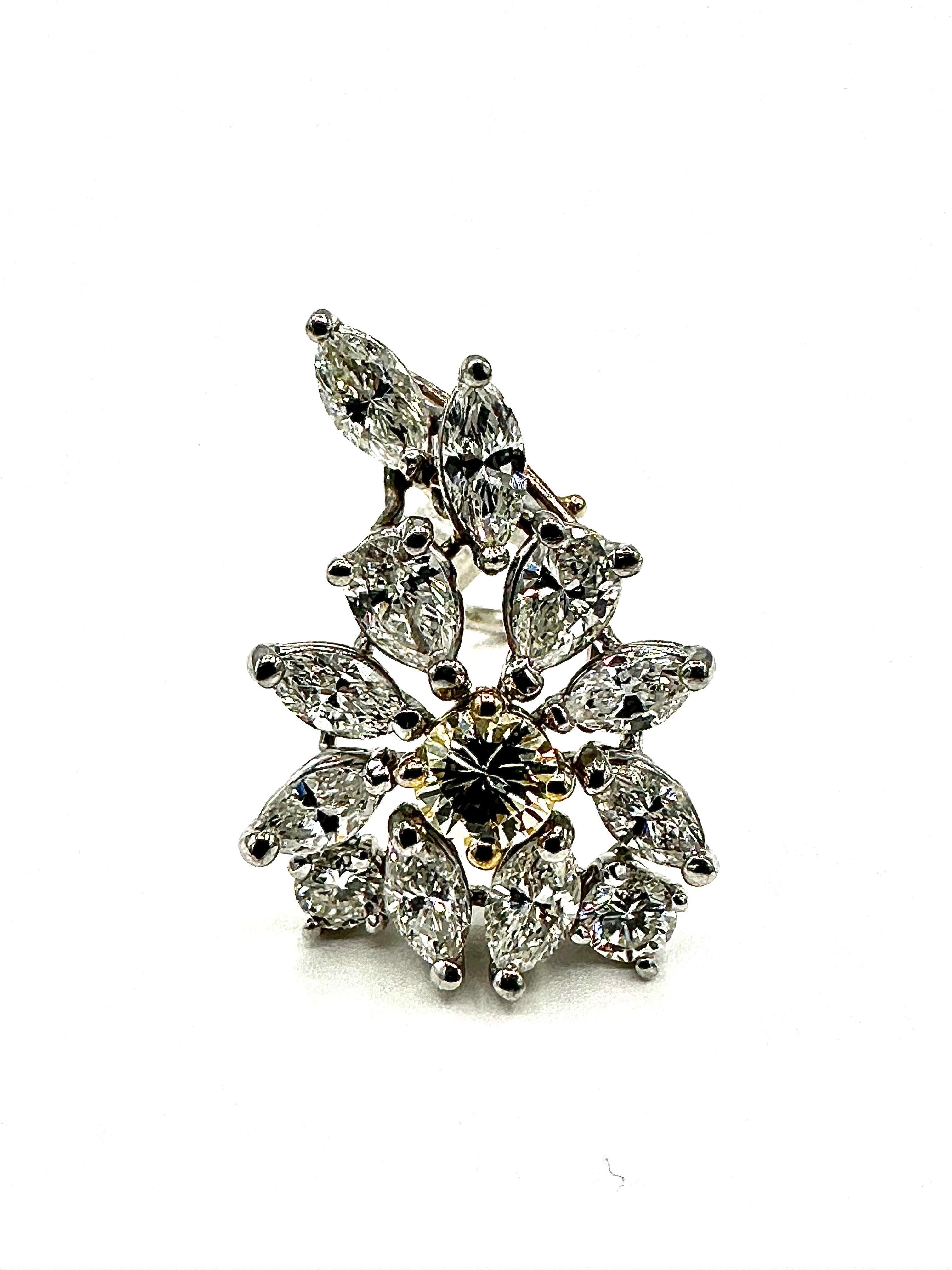 These earrings light up a room with all of their shimmer and shine!  The earrings are designed as a floral style cluster of multiple shaped Diamonds.  It is made up of round brilliant cuts, marquise shaped,  and pear shaped Diamonds totaling 4.48
