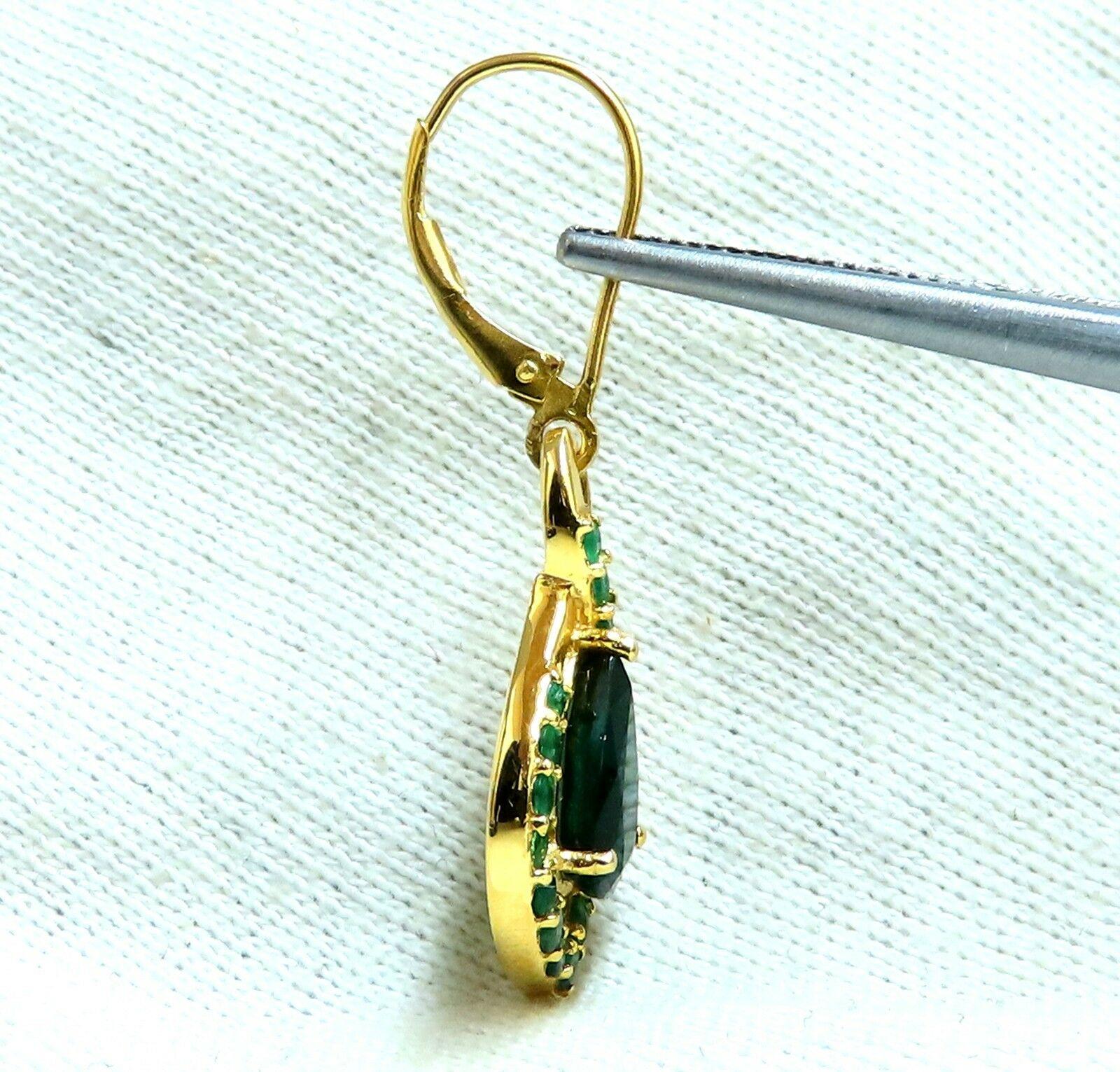 Halo Pear Dangles.

1.40 1.44ct. Natural (2) Emeralds

Emeralds: Pear Shaped brilliant cuts.

Transparent & Even Green tone.

Ranging: 9 x 6.5mm Each

Side Emeralds: 2.00ct

Round Cut, Transparent & Even Green Toned.

Emeralds Have been Oil