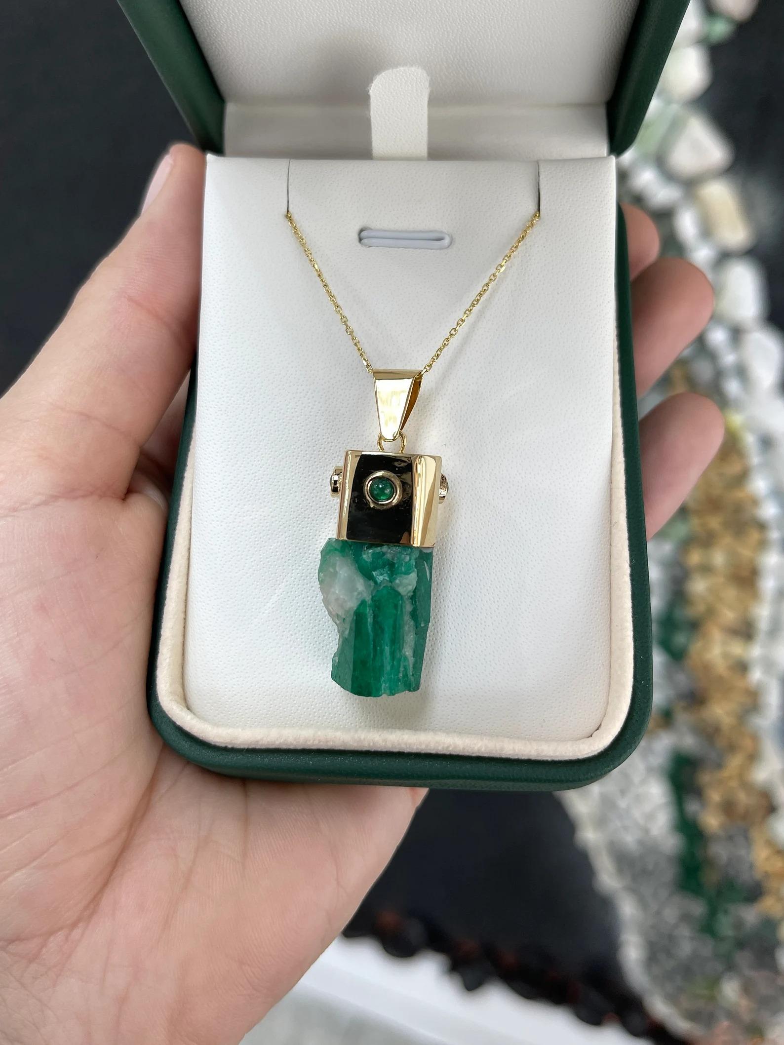 Showcased is a natural, rough emerald crystal pendant. An estimated 48 total carat weight of genuine, rough, Colombian emerald crystal is beautifully set in a hand-made 18K yellow gold cap. The Colombian emerald has a rich, deep green color and has