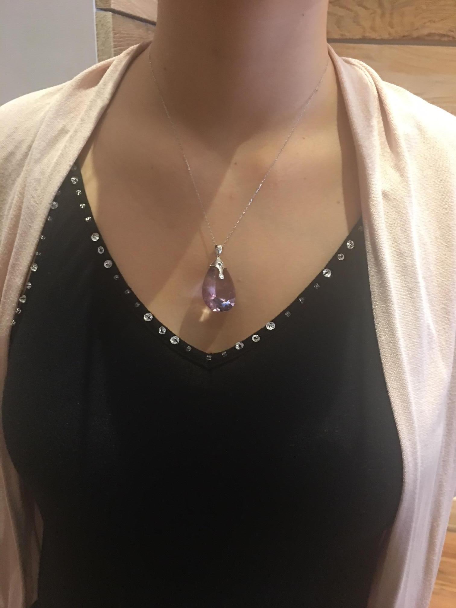 Stunning Necklace showcasing a beautiful 48.5 Carat Teardrop Amethyst enhanced with 2 Diamonds, weighing approx. 0.03 carat and 0.05 carat. Hand crafted in 18K white Gold and suspended from a 19 inch white Gold chain. A Perfect