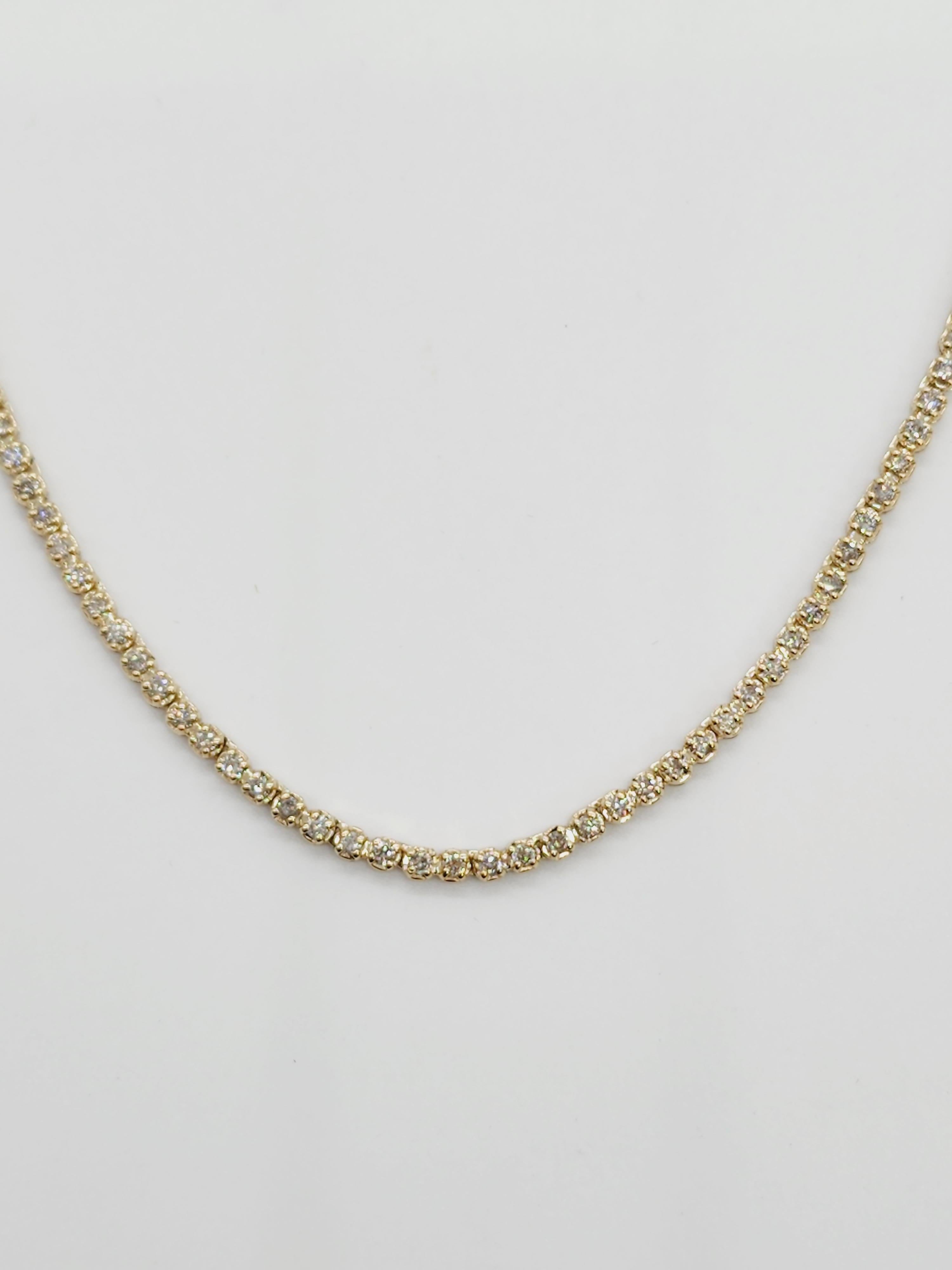 Brilliant and beautiful buttercup necklace, natural round-brilliant cut 
14k yellow gold buttercup setting. 
16 inch length. Average I Color, SI Clarity. 
