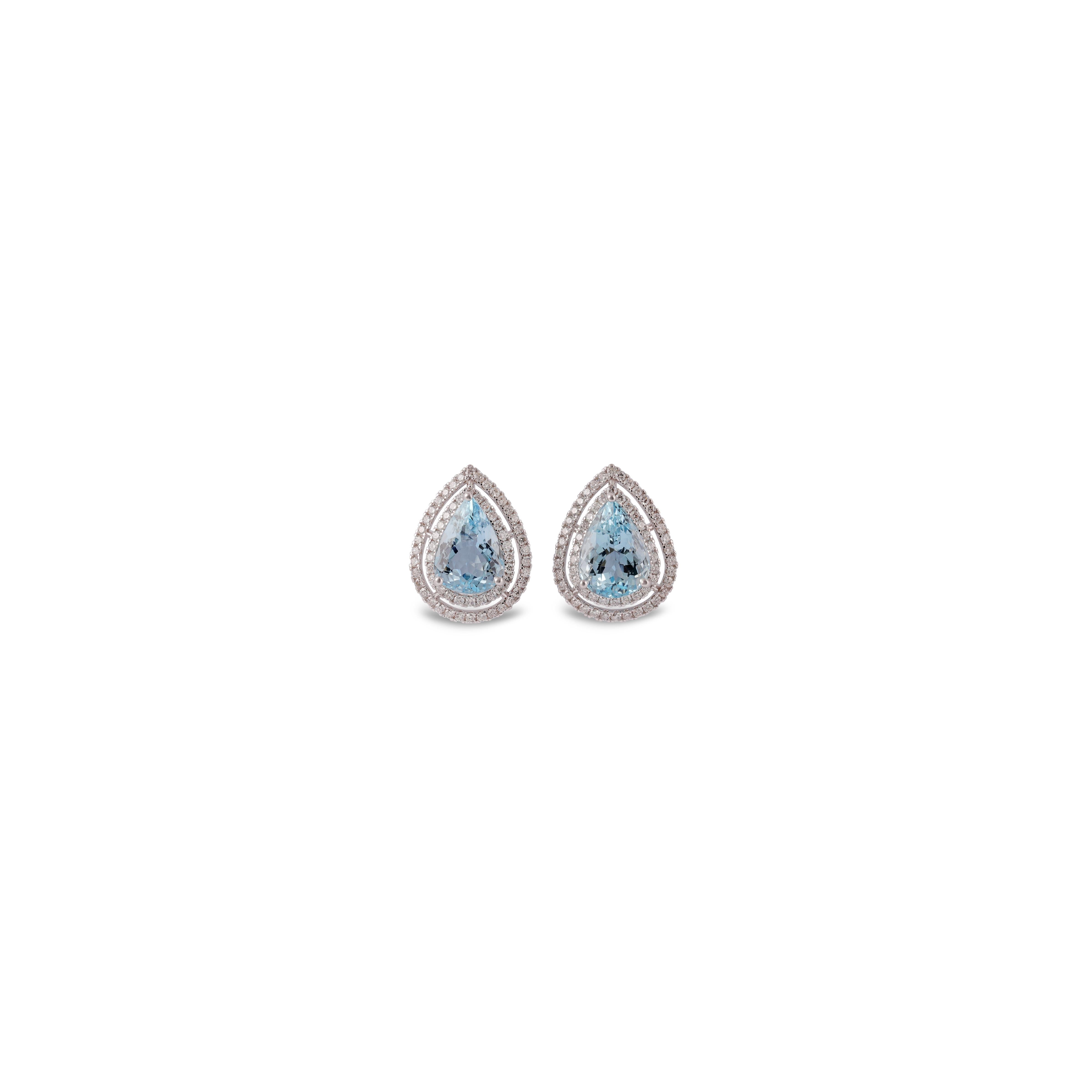 This is an elegant Aquamarine & diamond Earring studded in 18k White gold with 2 piece of Pear 0r Drop Cut  shaped  Aquamarine weight 4.85 carat which is surrounded by 124 pieces of round shaped diamonds weight 0.78 carat, this entire ring studded