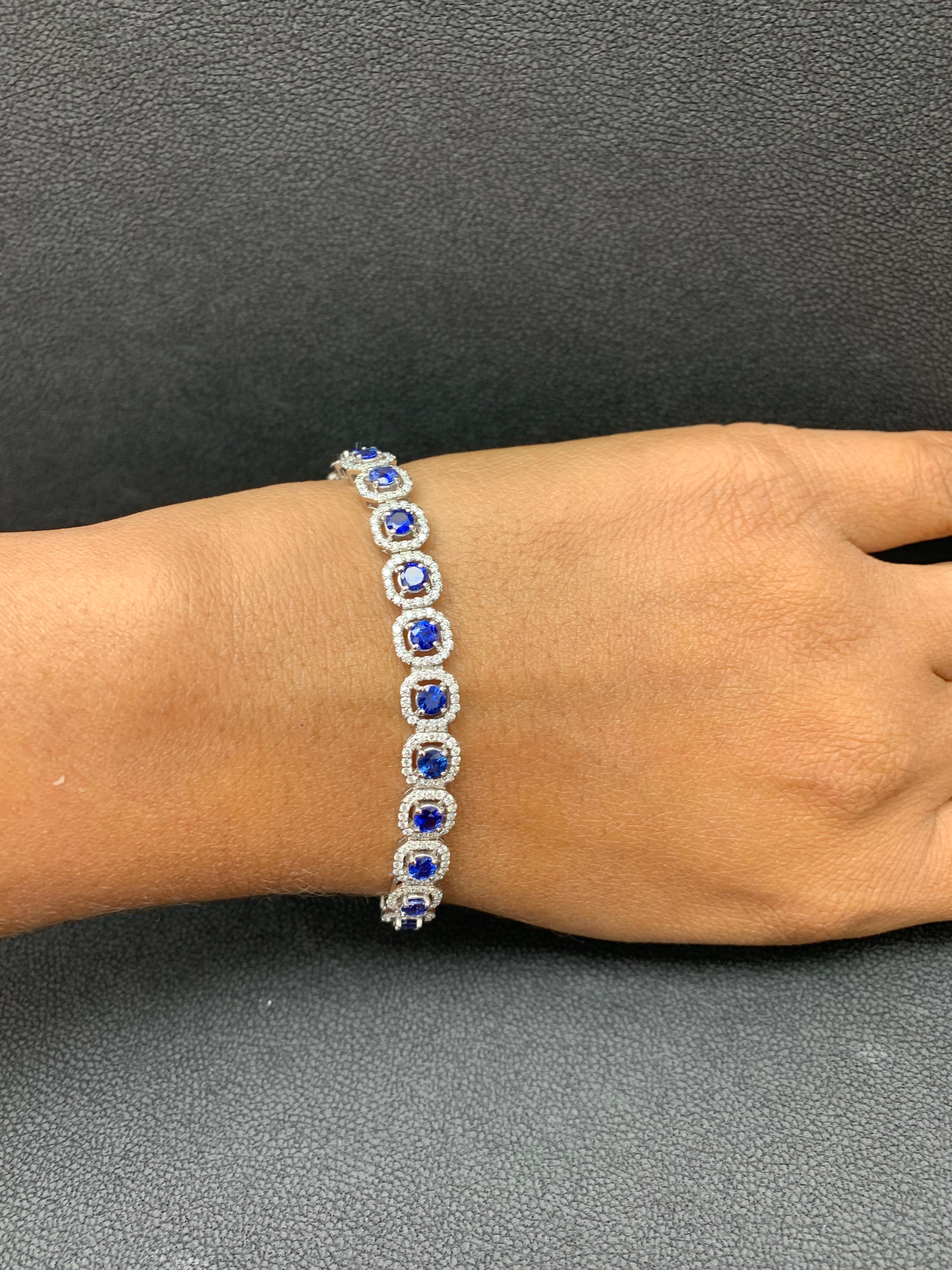 This gorgeous bracelet features 25 round brilliant blue sapphires weighing 4.85 carats total. Each stone is surrounded by a single row of small round diamonds weighing 2.40 carats total. Set in 14k white gold.

Style available in different price
