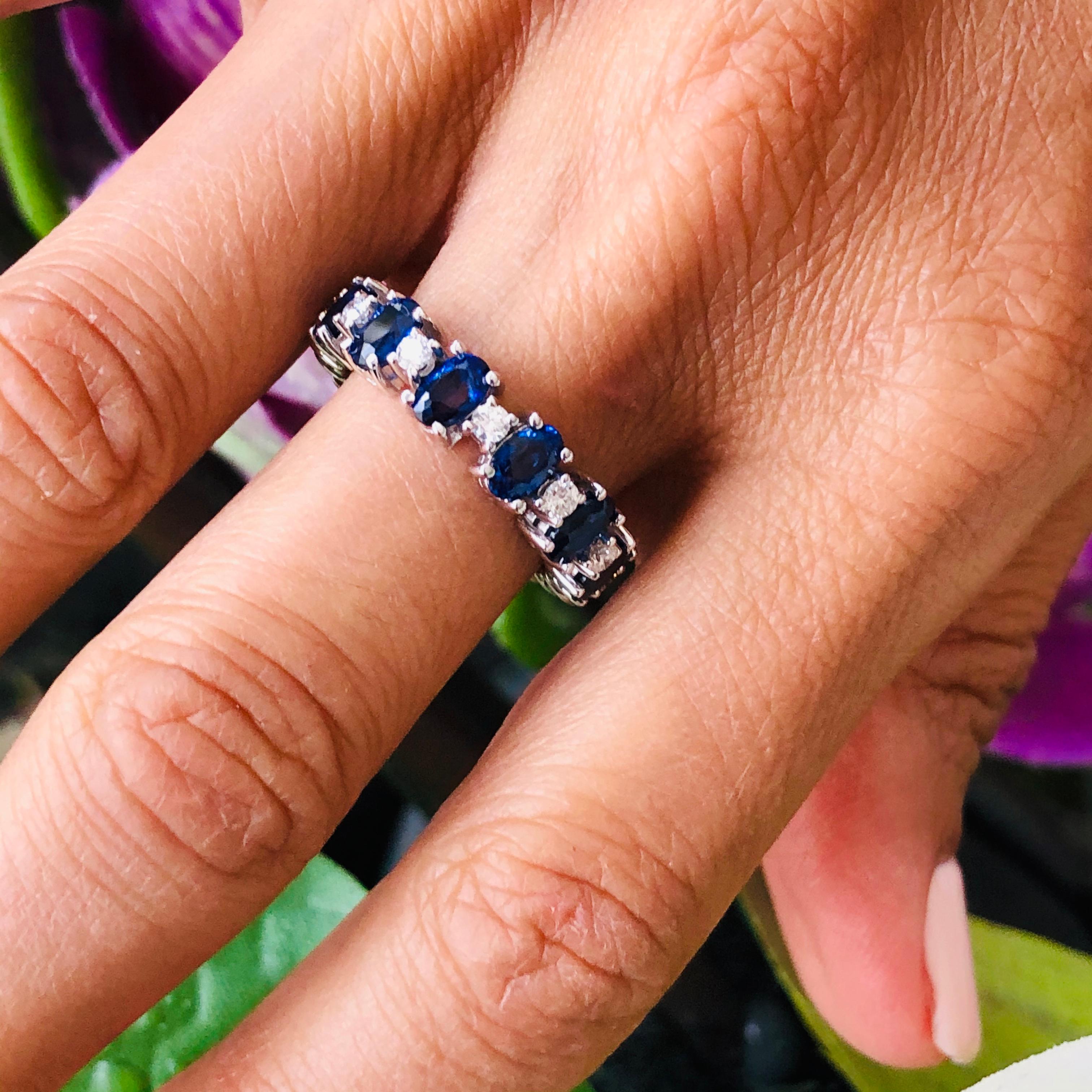 Offered here is a beautiful sapphire and diamonds eternity ring set in 18kt white gold. The ring has twelve ( 12 ) oval shape sapphires with an estimated total weight of 4.30 carats. The sapphire have a gorgeous deep blue color. In between each