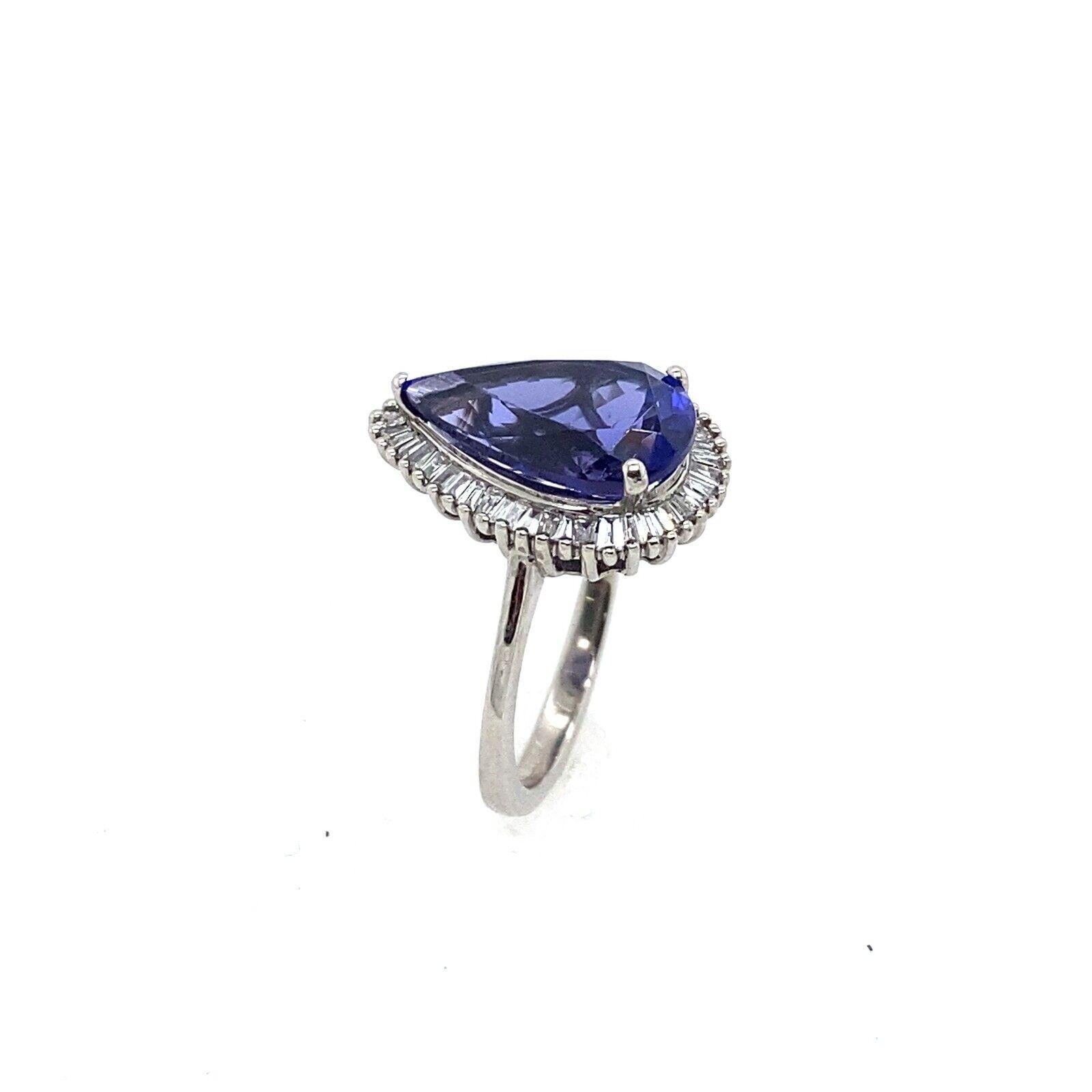 Round Cut 4.85ct Pear Shape Natural Tanzanite Surrounded by 0.42ct of Diamonds Ring For Sale
