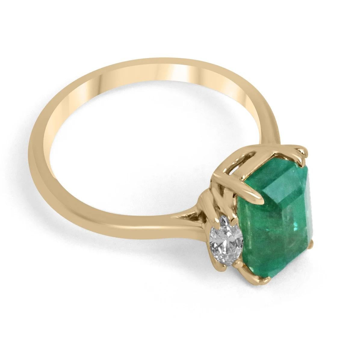 A remarkable emerald and diamond three-stone right-hand/engagement ring. This exceptional custom piece features a gorgeous emerald cut emerald from the origin of Zambia. The gemstone showcases a stunning medium dark green color, with a tint of