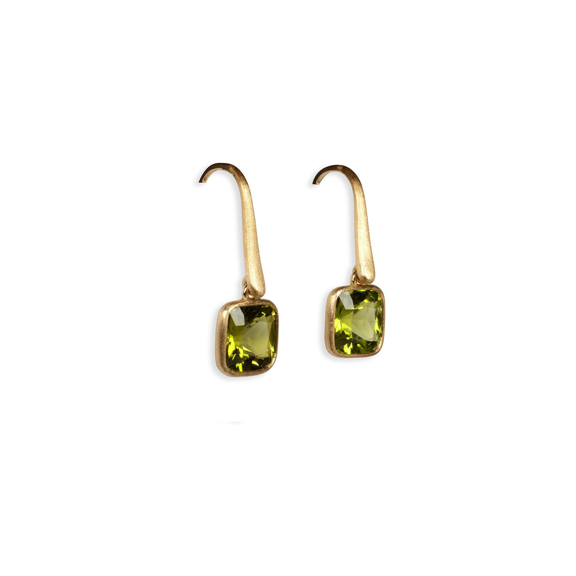 These 4.86-carat lusciously green peridot earrings create an effortless elegance and are the perfect addition to your wardrobe. Each earring has a slender tendril of 18-karat matte yellow gold that delicately sweeps down to be met by a glowing