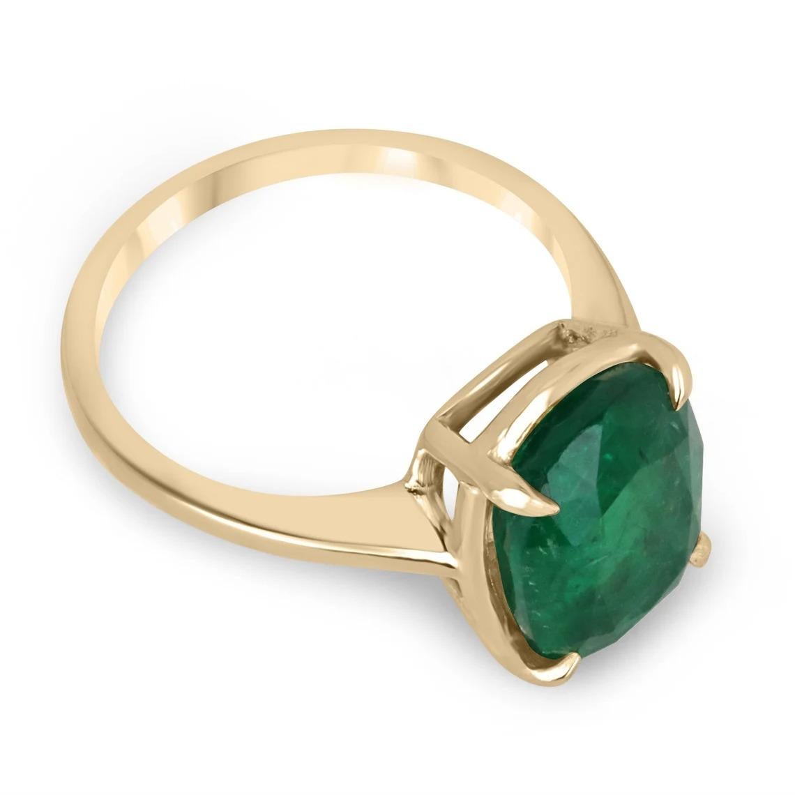 Displayed is a classic emerald solitaire, cushion-cut, engagement ring/right-hand ring in 14K yellow gold. This gorgeous solitaire ring carries a full 4.86-carat emerald in a classic prong setting. Fully faceted, this gemstone showcases excellent