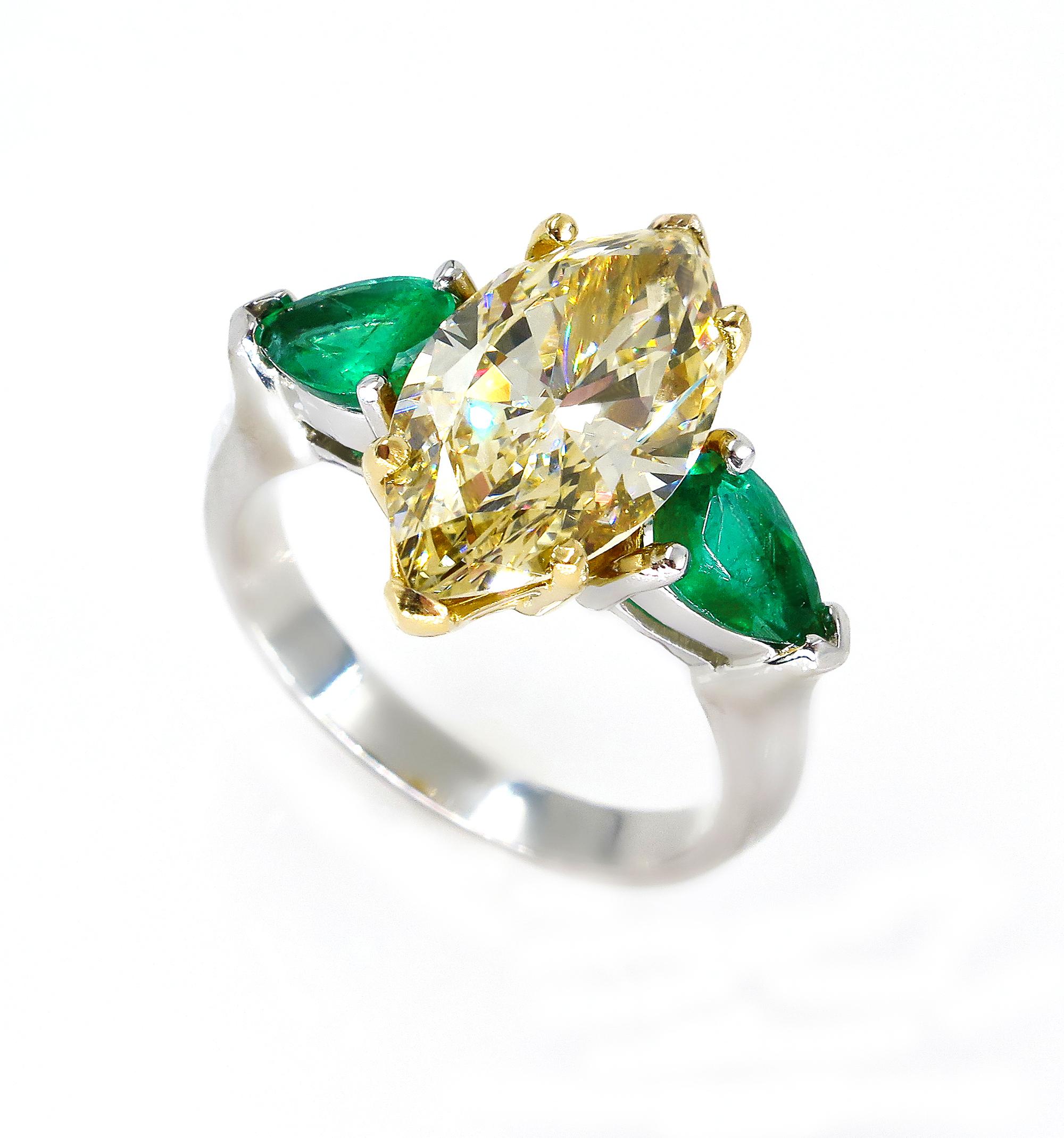 The Ultimate Luxury. A SUPER RARE Find for Diamond Lovers or Rare Gems Collectors! Spectacular Trilogy Large Fancy Yellow Marquise Shape Diamond and Green Emerald Ring in Platinum and 18k Gold.

More rare than a colorless diamond, a fancy color