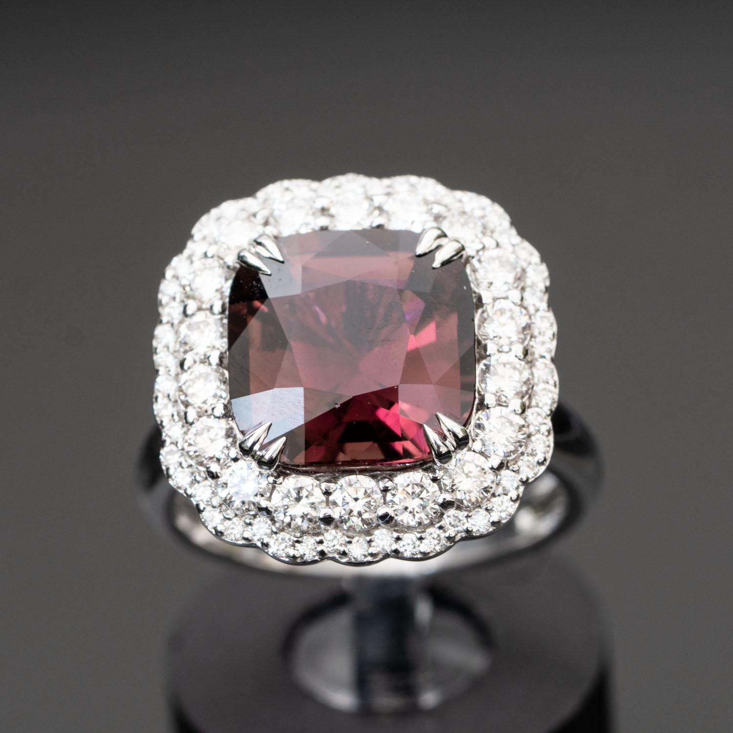 This cushion cut red tourmaline diamond ring is simply stunning! The large 4.86 carat (10.80mmX10.53mm) natural central tourmaline surrounded by 1.16 carat sparkling natural diamonds D- F VVS.

Main Stone: Natural, Genuine Tourmaline
Carat: 4.86