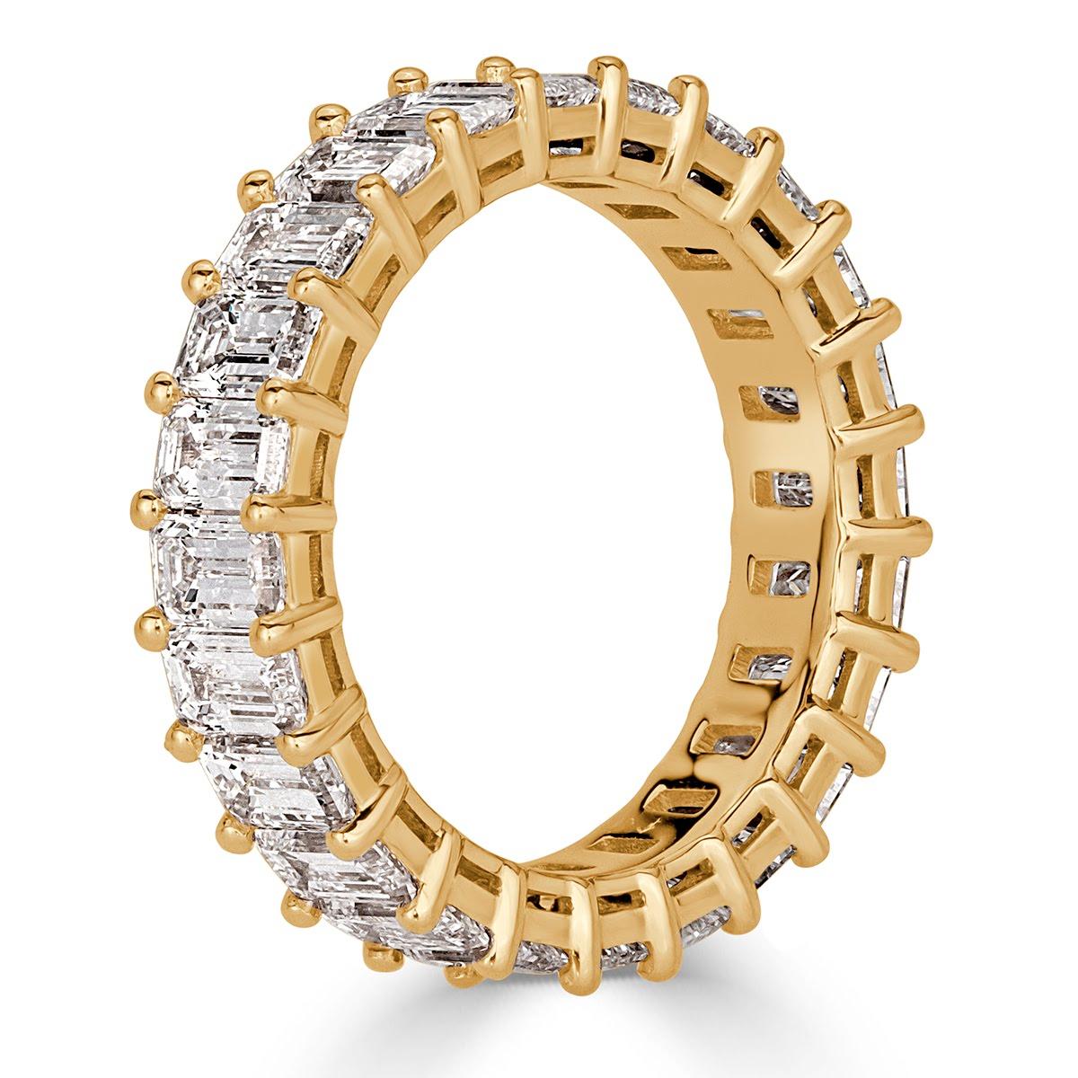 Handcrafted in 18k yellow gold, this captivating emerald cut diamond eternity band showcases 4.87ct of perfectly matched emerald cut diamonds graded at E-F colors, VVS2-VS1 clarities. All eternity bands are shown in a size 6.5. We custom craft each