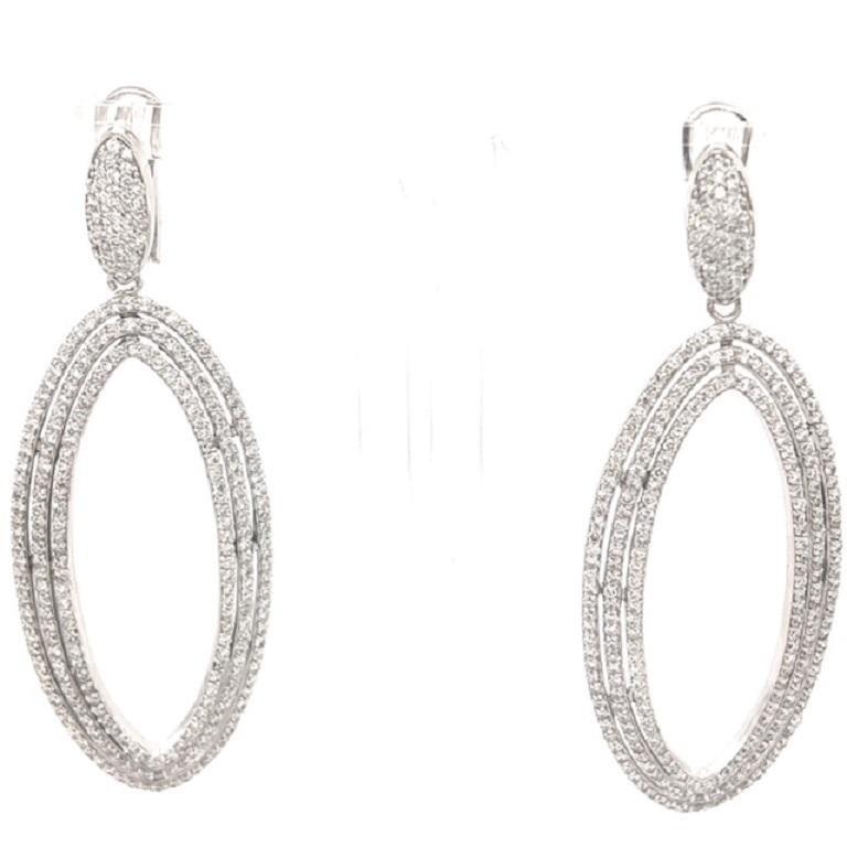 These earrings have Natural Round Cut White Diamonds that weigh 4.87 carats. The clarity and color of the earrings are SI1-F. 

They are 2.5 inches long and are curated in 14 Karat White Gold with an approximate weight of 20.0 grams. 

Stunning