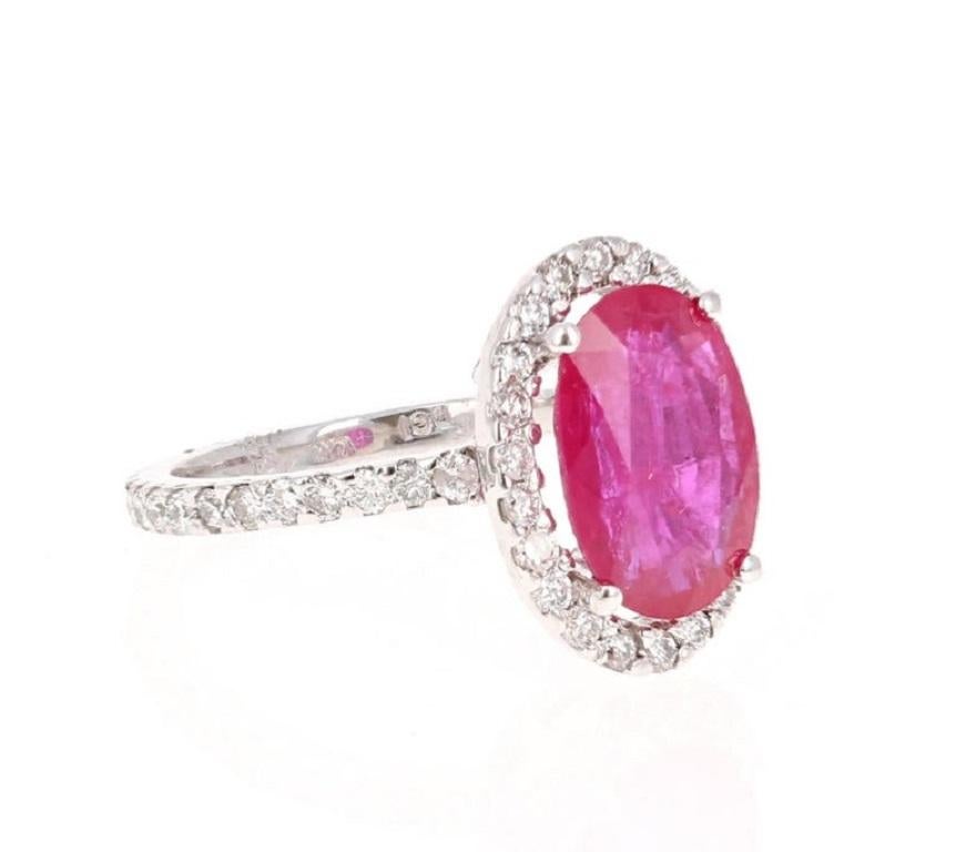 This is a gorgeous Oval Cut Ruby and Diamond ring.  The Ruby has origins from Southern Africa (Republic of Mozambique) and is 3.96 carats. It has a Halo of 46 Round Cut Diamonds weighing 0.91 carat. The total carat weight of this ring is 4.87