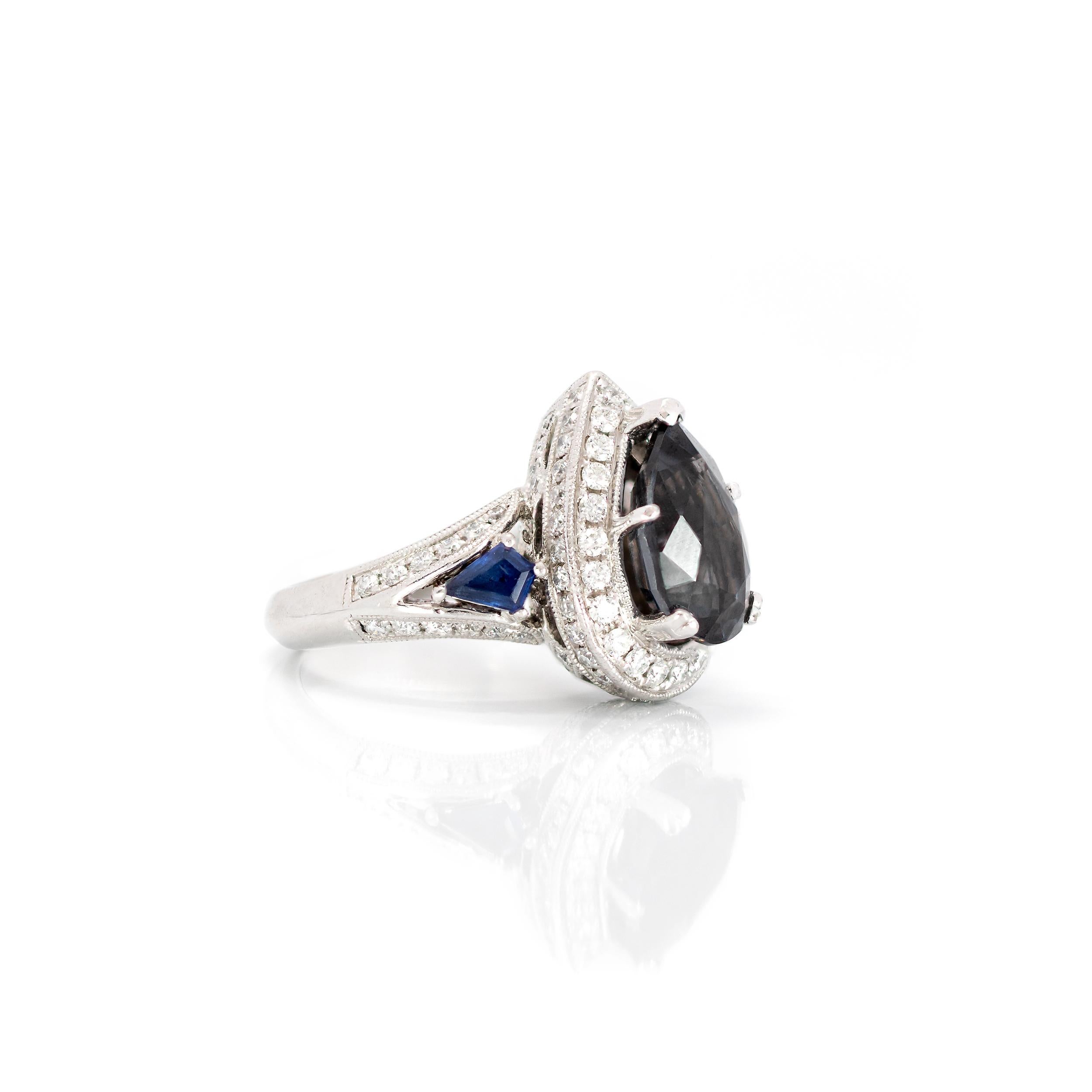 Such a beautifully designed ring with a sophisticated Pear-shaped Lavender Spinel surrounded by Diamonds, including an intricate profile design to ensure a beautiful look at every possible angle.  The Kite-shaped diamonds running from the Spinel