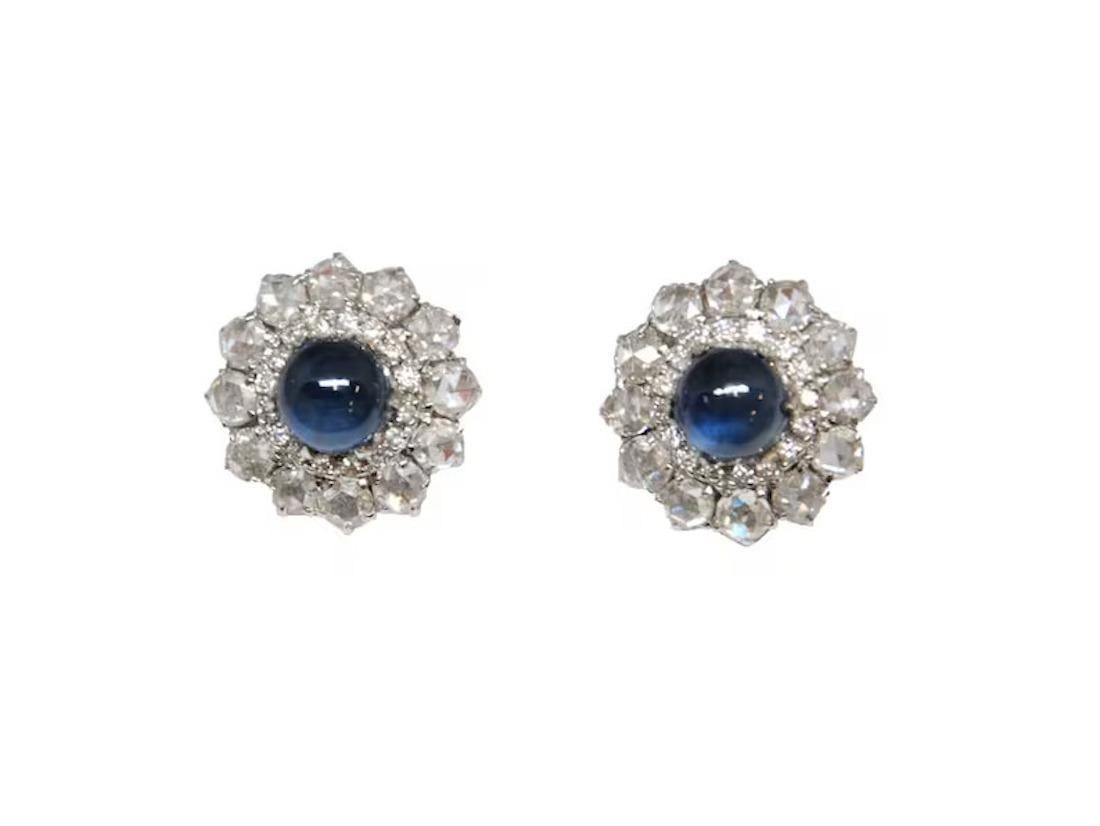 Super unique natural Cabochon Sapphire & Diamond Earrings features 2 cabochon shape sapphires weighing 4.87 ct. The sapphires are surrounded by 56 rose-cut diamonds weighing 3.32 ct set in 18k white gold.