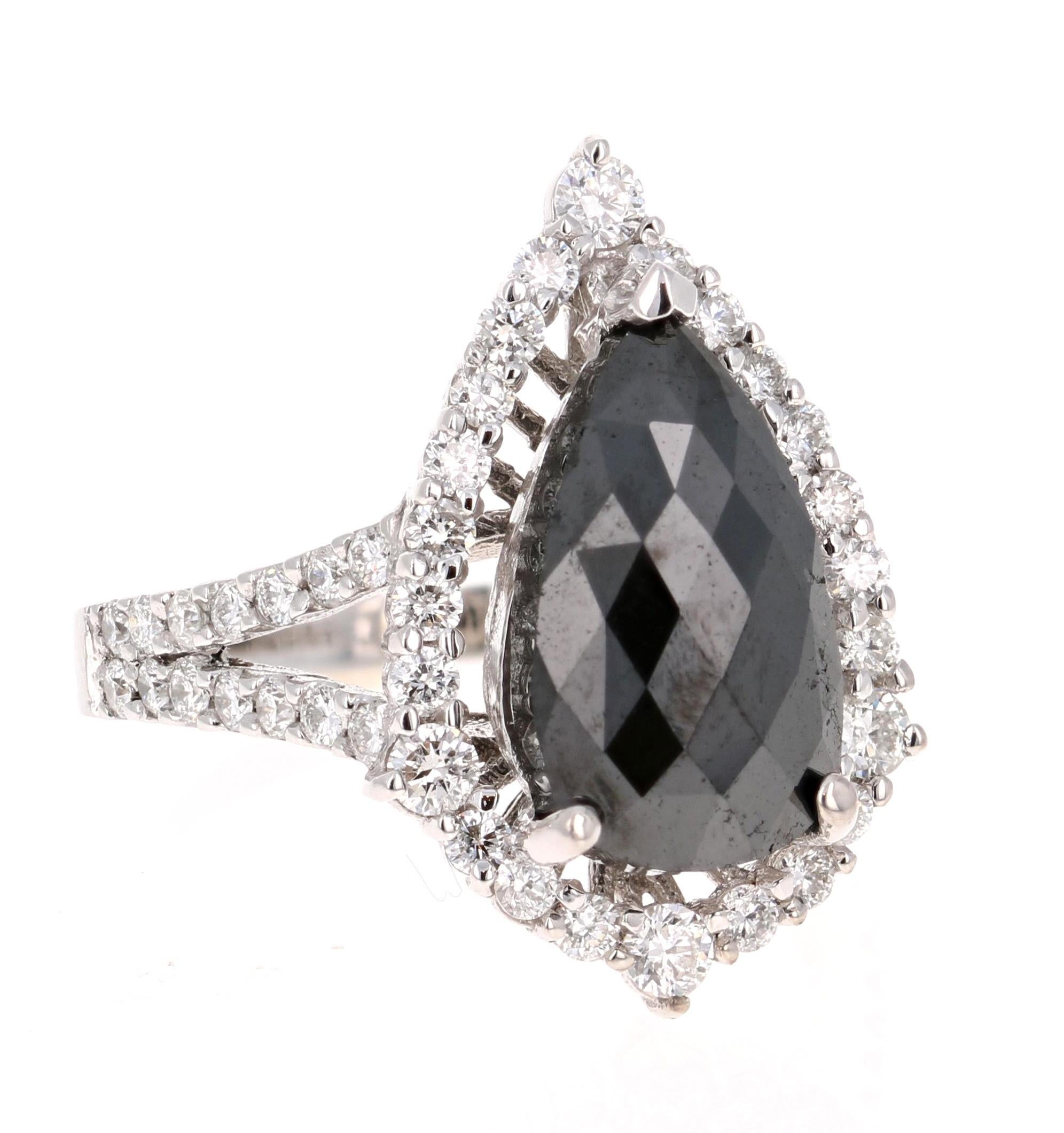 A stunner that can transcend into a unique engagement ring!! 

The Black Diamond is a Pear Cut and weighs 3.95 carats. The Black Diamond is a natural diamond that has been color-treated to enhance the black color. The Black Diamond is surrounded by