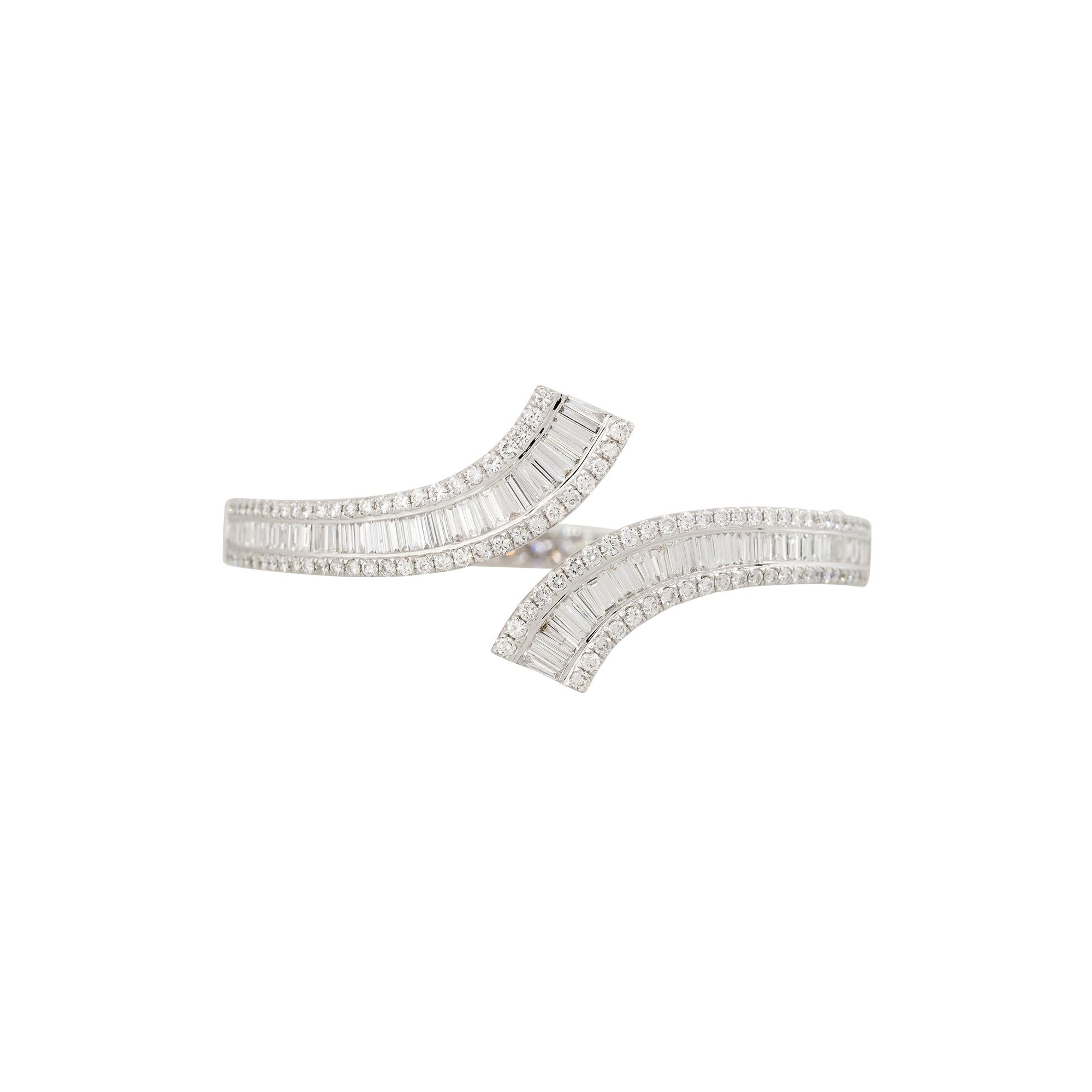 Product Style: Diamond Bypass Cuff Bracelet
Material: 18 Karat White Gold
Diamond Details: There are approximately 2.89 carats of Baguette cut diamonds (75 stones) and approximately 1.99 carats of Round Brilliant cut diamonds (112 stones). The total