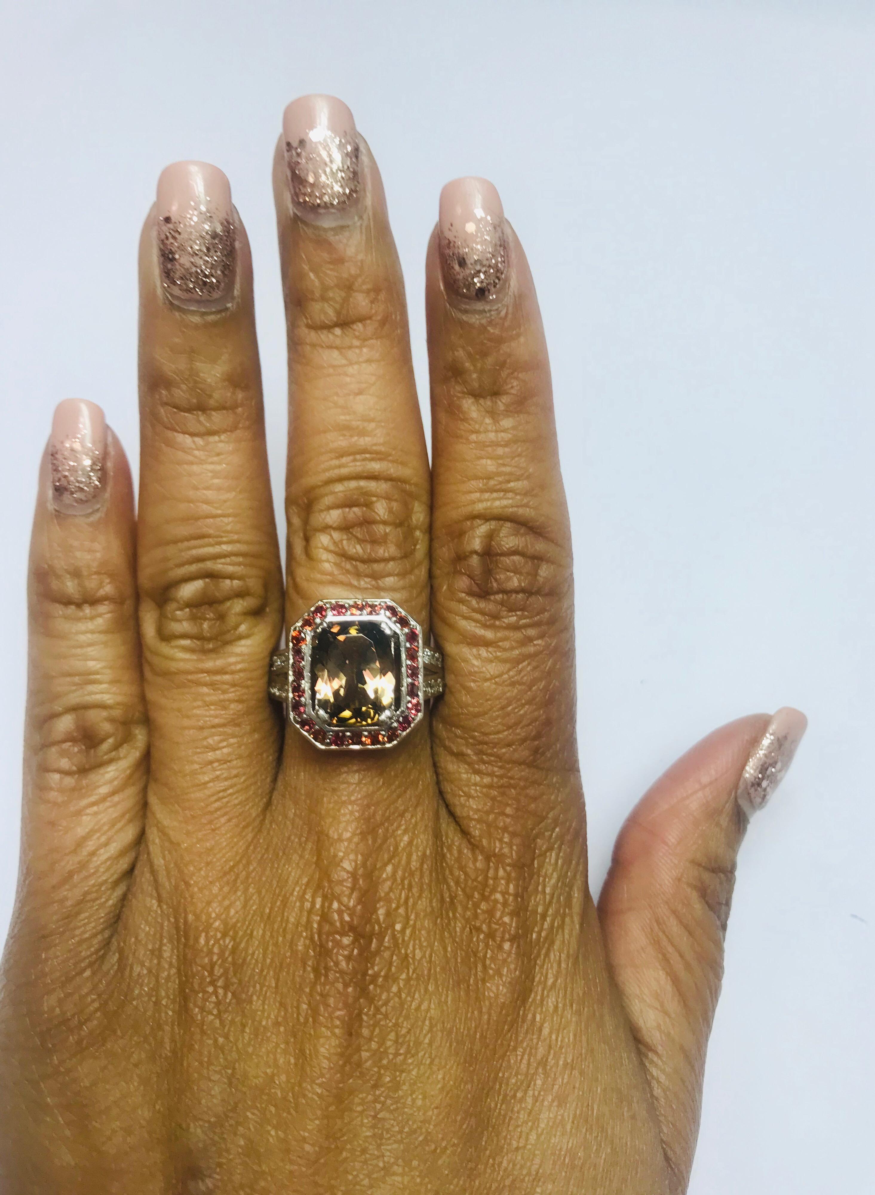This ring has a Oval-Cushion Cut Brown Tourmaline that weighs 3.09 Carats. Floating around the tourmaline are 25 Round Cut Diamonds in a halo weighing 0.71 Carats. Further embellished are 62 Round Cut Diamonds that weigh 1.08 Carats. (Clarity: SI,