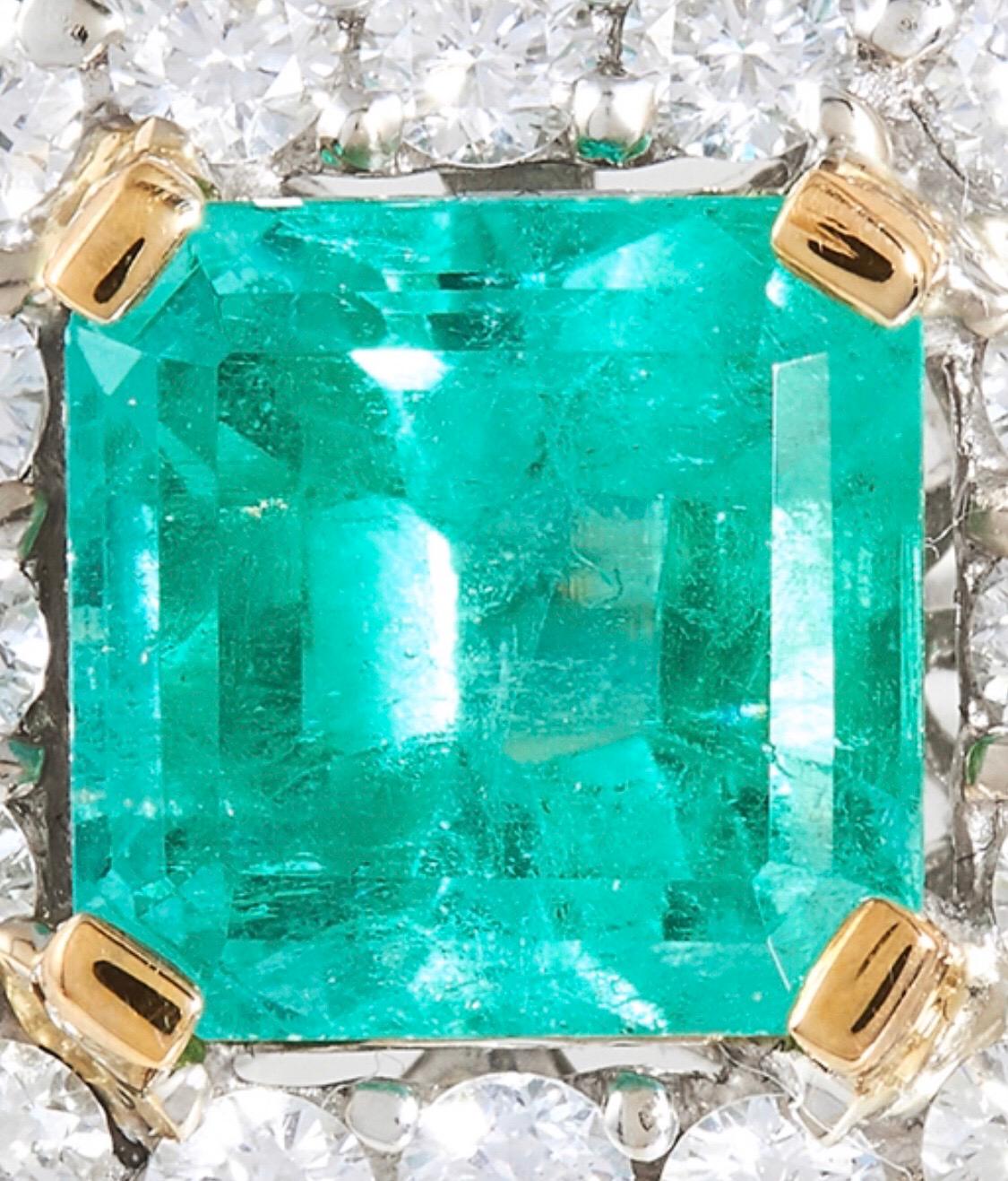 Colombian Emerald Diamond Dress Ring In 18 Karat White Gold, the emerald cut emerald of 4.88 carats within concentric borders of round cut diamonds, with further step and round cut diamonds to the shoulders, totalling 5.03 carats, stamped 750, size