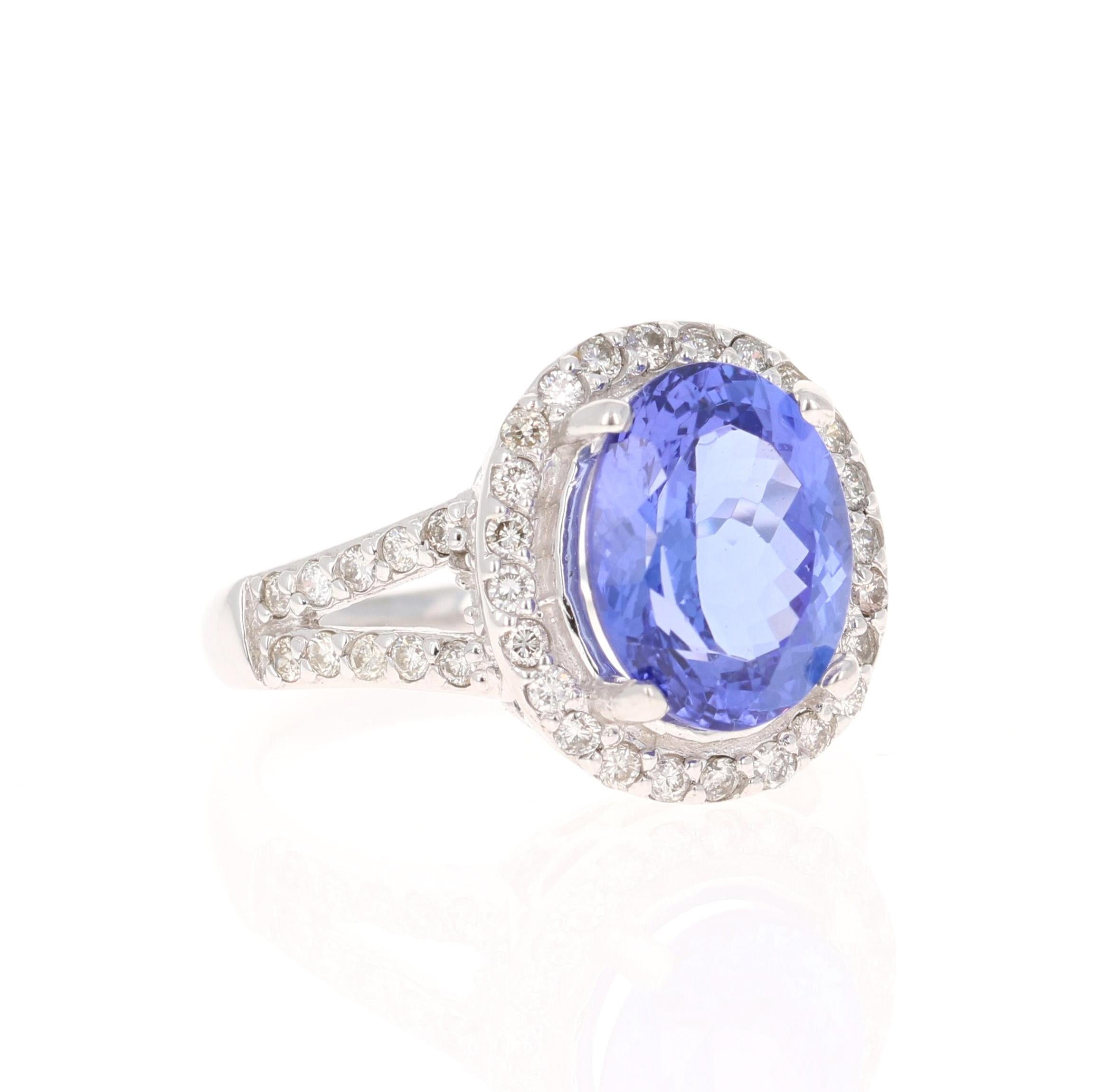 This beautiful ring has a vivid 4.33 Carat Oval Cut Tanzanite. The Tanzanite is surrounded by 44 Round Cut Diamonds that weigh 0.56 Carats. (Clarity: SI, Color: F)  The total carat weight of the ring is 4.89 Carats.  

The ring is made in 14K White