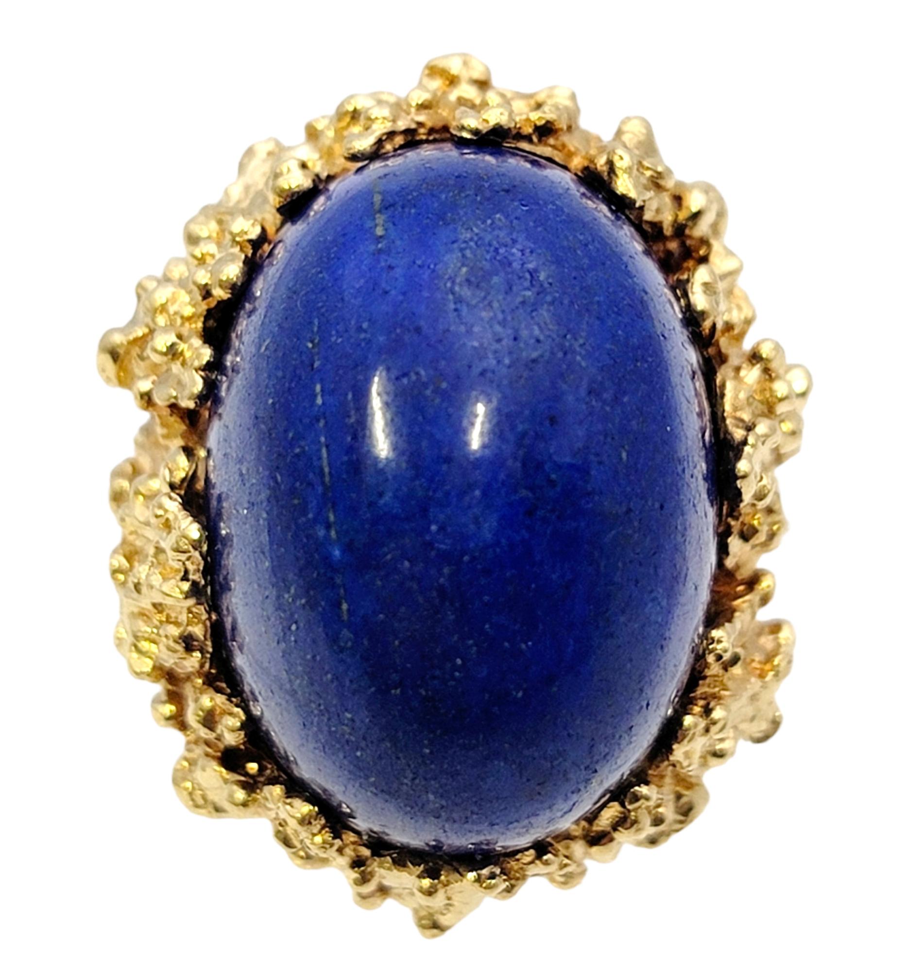 Ring size: 5

This spectacularly bold and beautiful domed cocktail ring is sure to impress. The massive natural lapis stone sits high off the finger, demanding the viewers attention, while the rest of the piece fills the finger from end to end with