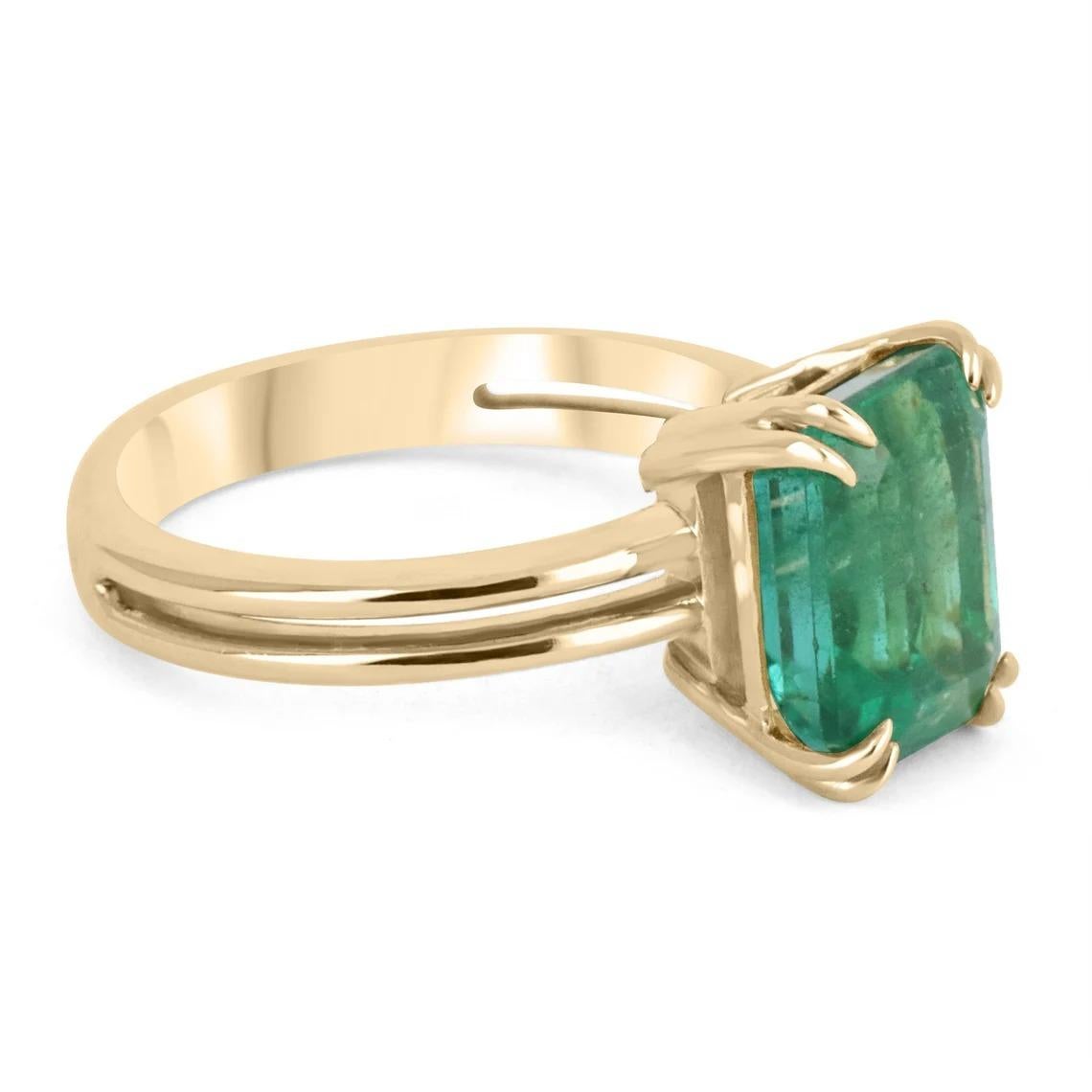 Behold this stunning 4.89-carat Zambian emerald solitaire ring. The large, natural emerald weighs a full 4.89-carats. The gem showcases a gorgeous dark green color and almost great eye clarity with minor flaws; as these are natural earth-mined gems.
