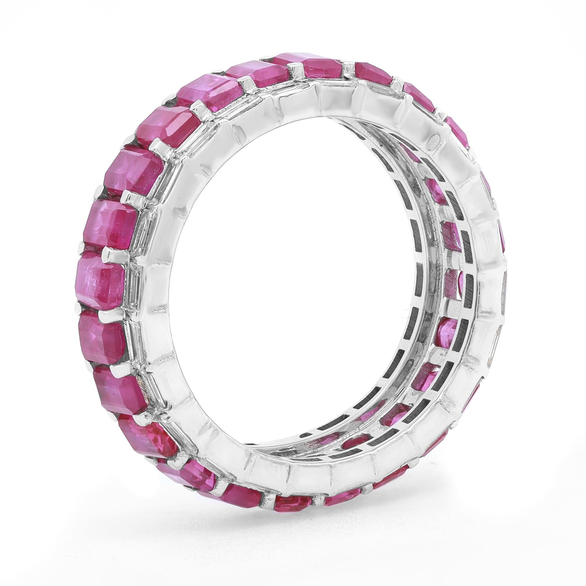 This stunning eternity band features prong set Emerald Cut Rubies as a center row with Baguette cut diamonds outline. The stones are beautifully circling all the way around the band and are set in fine 14k white gold. Ruby total carat weight: 4.89.