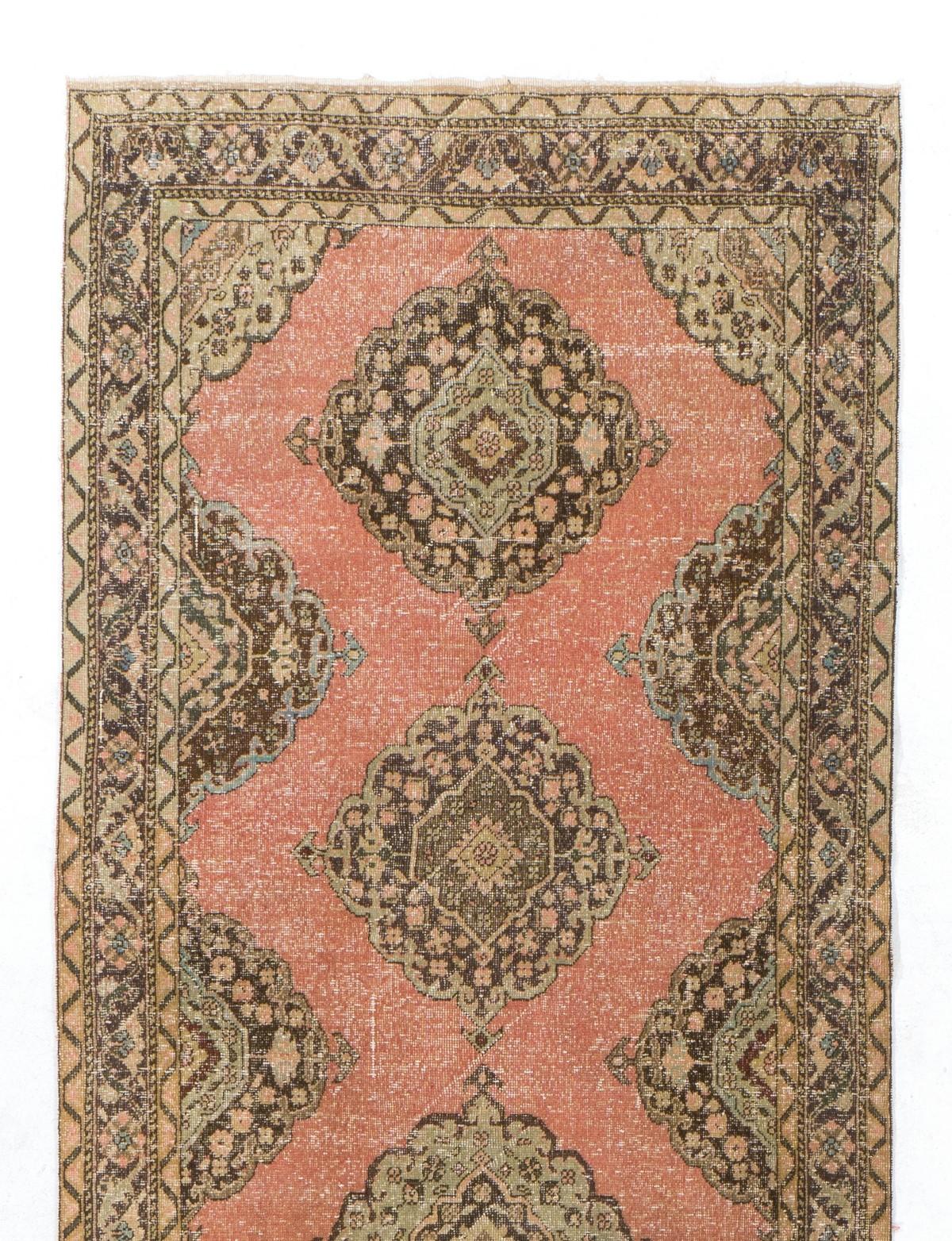 A vintage Turkish runner rug for hallway decor It was hand-knotted in the 1960s with low wool on cotton foundation and features a multiple geometric medallion design. It is in very good condition, professionally-washed, sturdy and suitable for areas