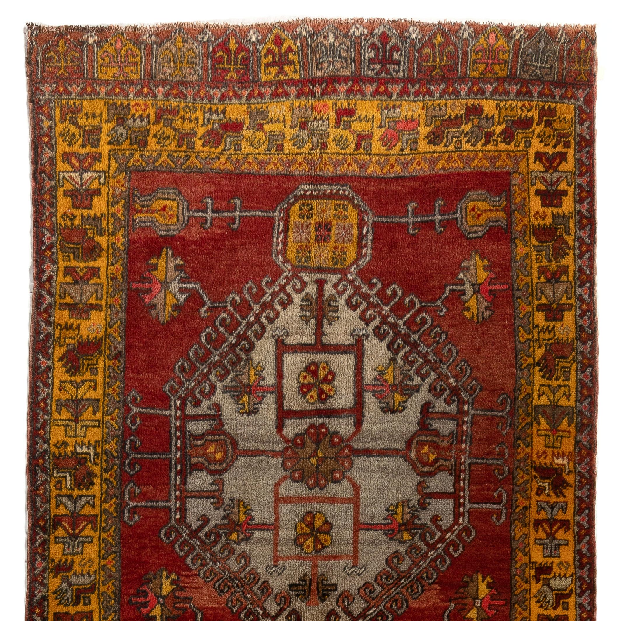 A vintage Central Anatolian village runner rug with a gorgeous linked medallions design decorated with carefully assembled details in glowing, saturated colors of red and saffron, as well as shimmering hues of gray and very light blue. This rug was