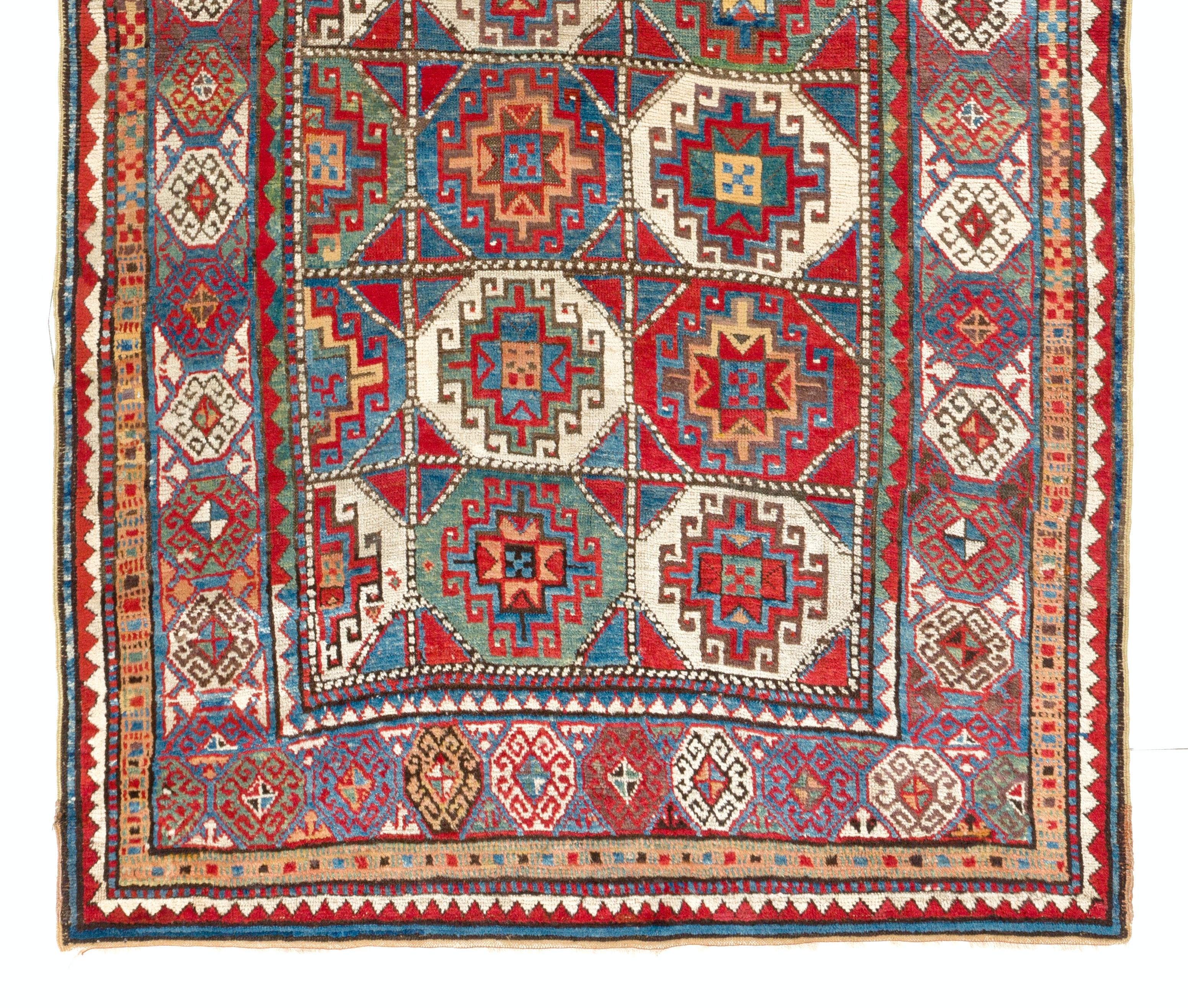 An antique Caucasian Moghan Kazak rug made of soft vegetal dyed lamb's wool. The rug is in very good condition with even medium pile. 
Size: 4.8 x 6.8 Ft.