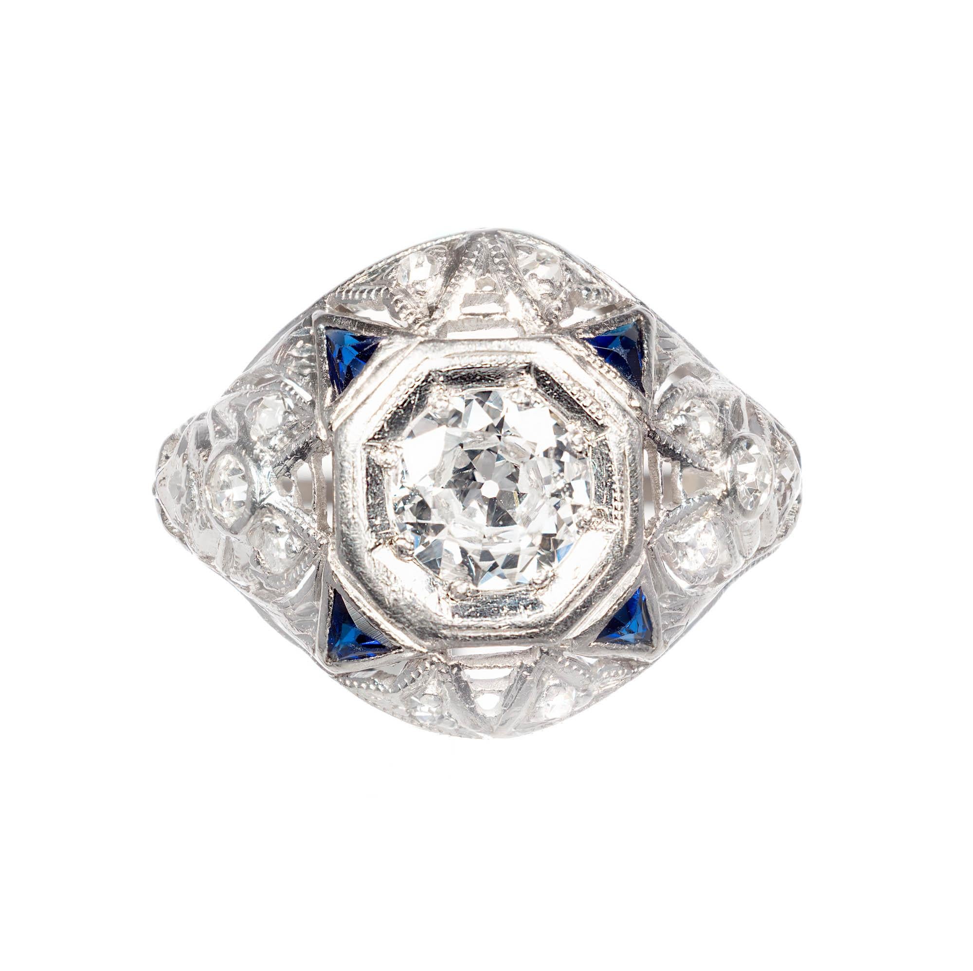 .49ct Diamond Sapphire Platinum Art Deco engagement ring. Diamond Platinum Art Deco design ring. Center Diamond is bezel set with smaller Diamonds and triangular cut Sapphires accenting around the center and down the shank.

1 round transitional cut
