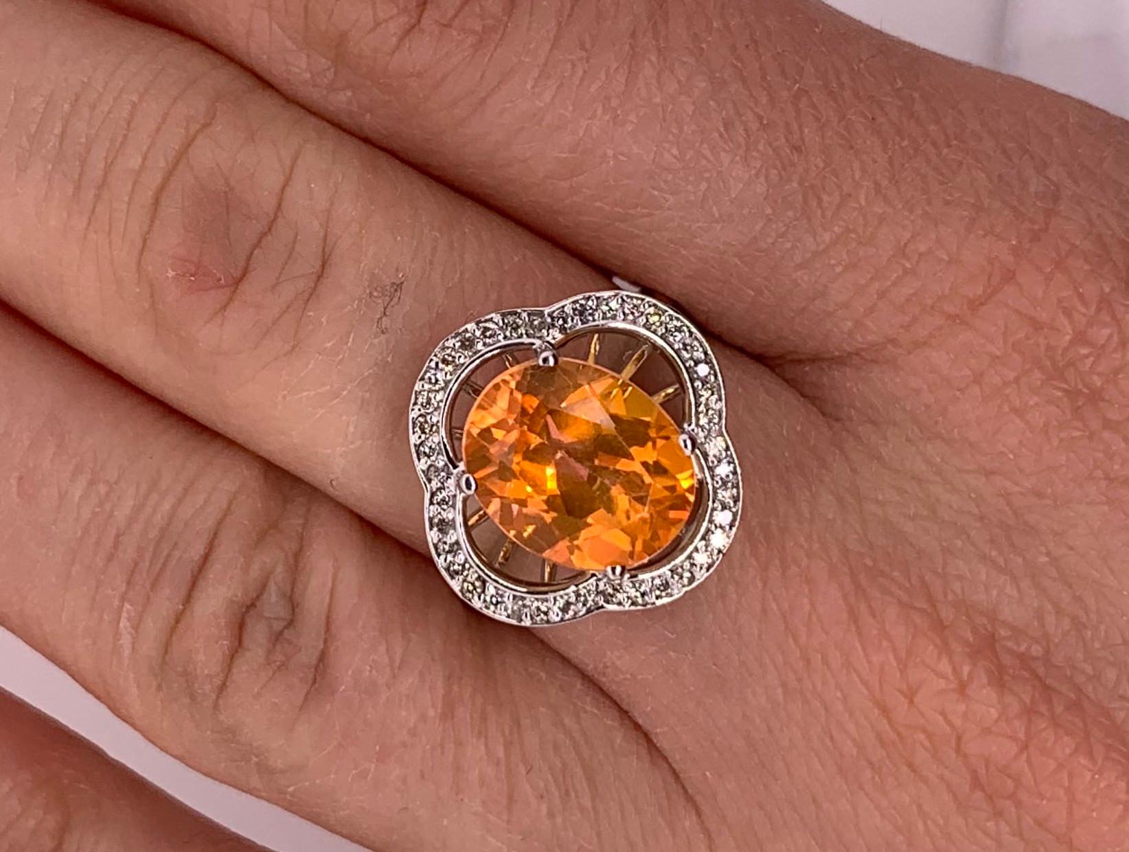 Material: 14k White Gold 
Stone Details: 1 Oval Shaped Sunset Topaz at 4.9 Carats - Measuring 9 x 11 mm
Diamond Details: 40 Brilliant Round White Diamonds at 0.20 Carats. SI Clarity / H-I Color. 
Ring Size: 5.5. Alberto offers complimentary sizing