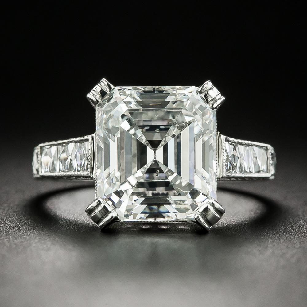 This resplendent engagement ring is crowned with a dazzling 4.90 carat emerald-cut diamond (accompanied by a GIA Diamond Grading Report stating: I color - SI2 clarity) reflecting mirror-like flashes of bright white light and prismatic colors. The