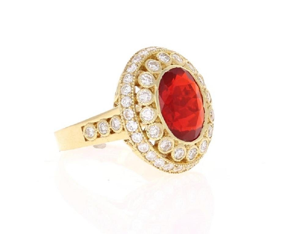 Bold, Beautiful and Bright Red Mexican Fire Opal Cocktail Ring

The Red Oval Cut Fire Opal weighs 3.30 Carats and has 52 Round Cut Diamonds that weigh 1.60 Carats. The clarity and color of the diamonds are SI-F. The total carat weight of the ring is