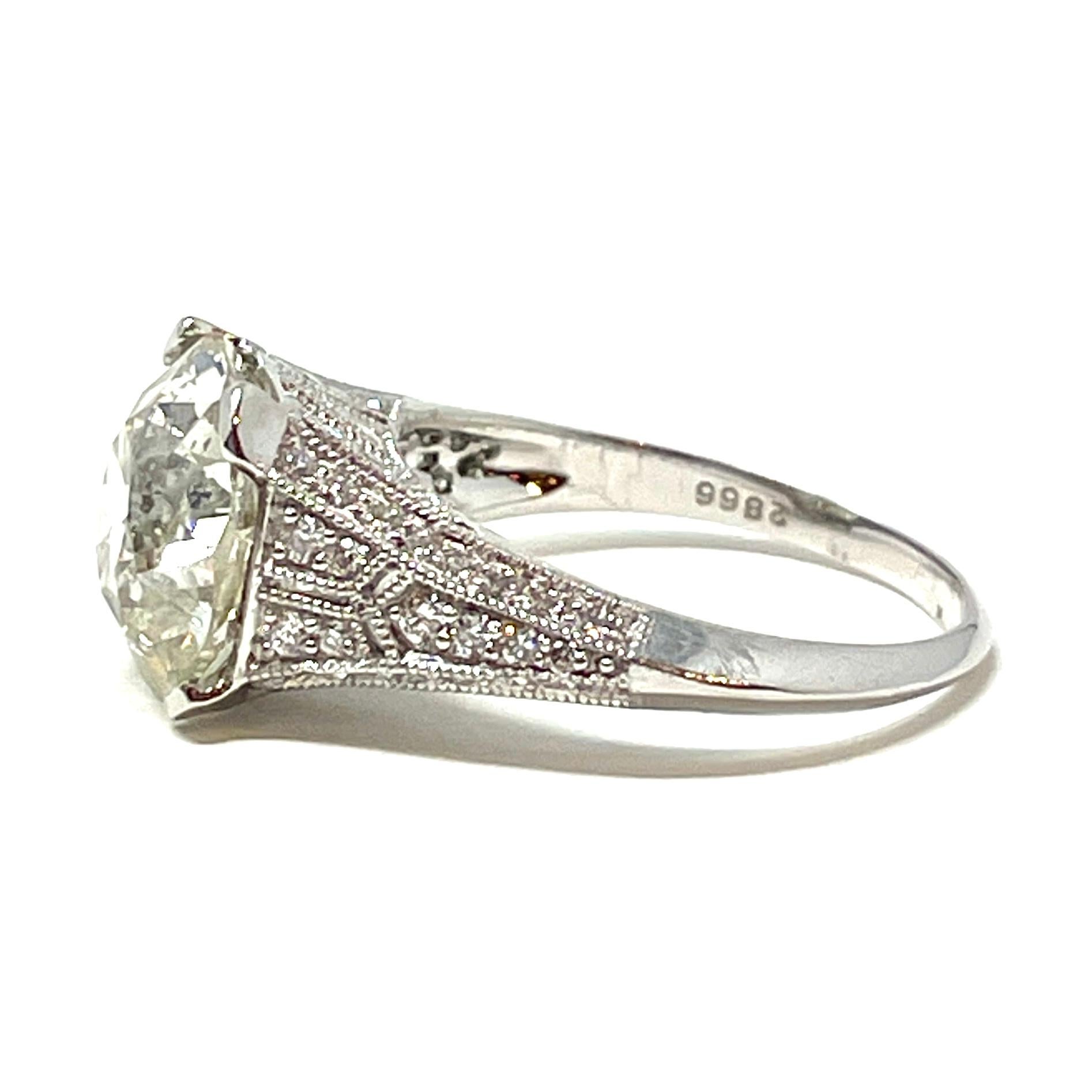Women's or Men's 4.90 Carat Old European Cut Diamond in a Diamond and Platinum Ring For Sale