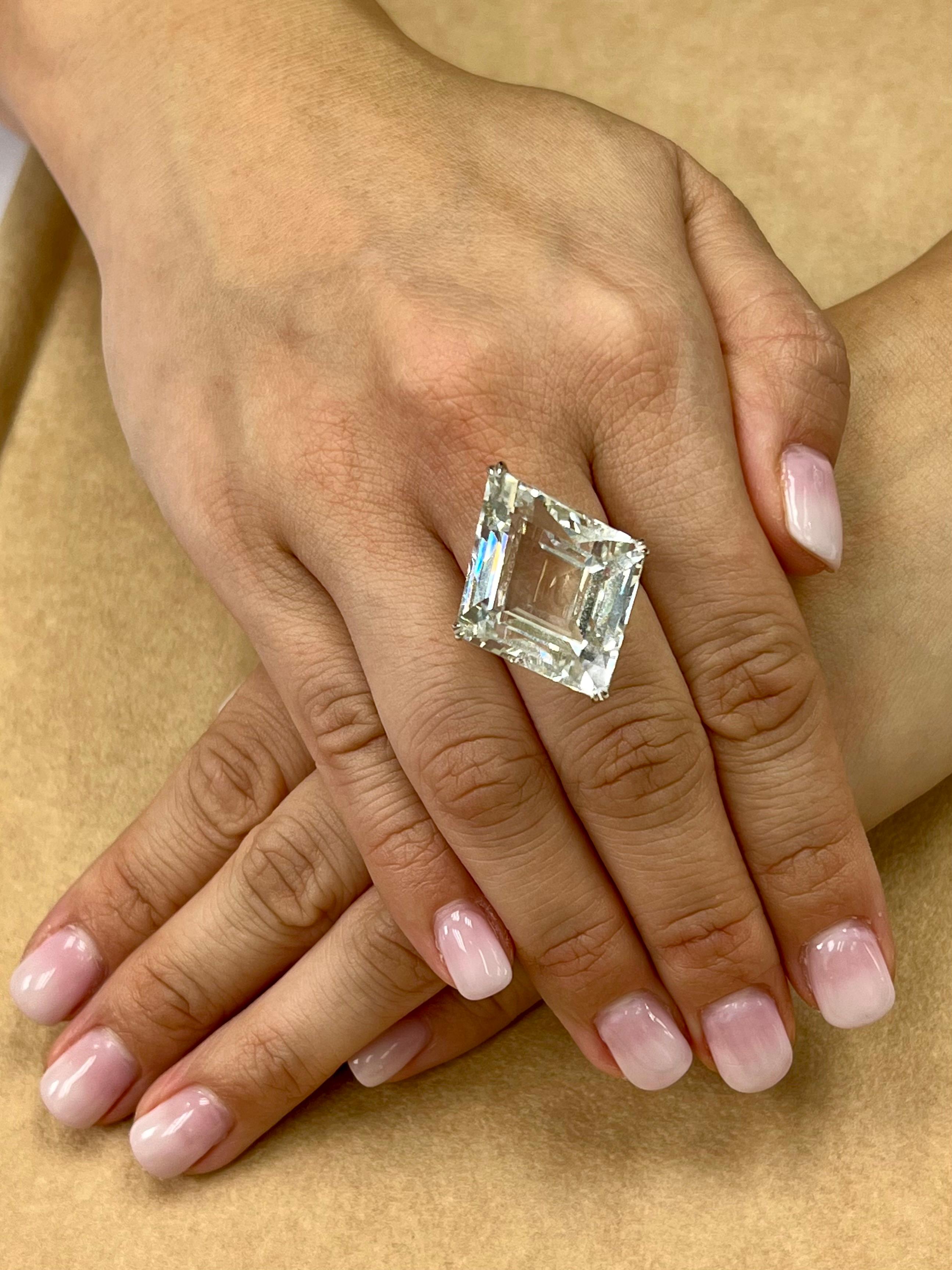 Please check out the HD video! Big statement piece! Here is a super nice white Topaz and diamond ring It is set in 18k Rose gold and 18k white gold. The center Topaz is a stunning 49.02Cts. Not only is the size impressive, the diamond shaped / kite