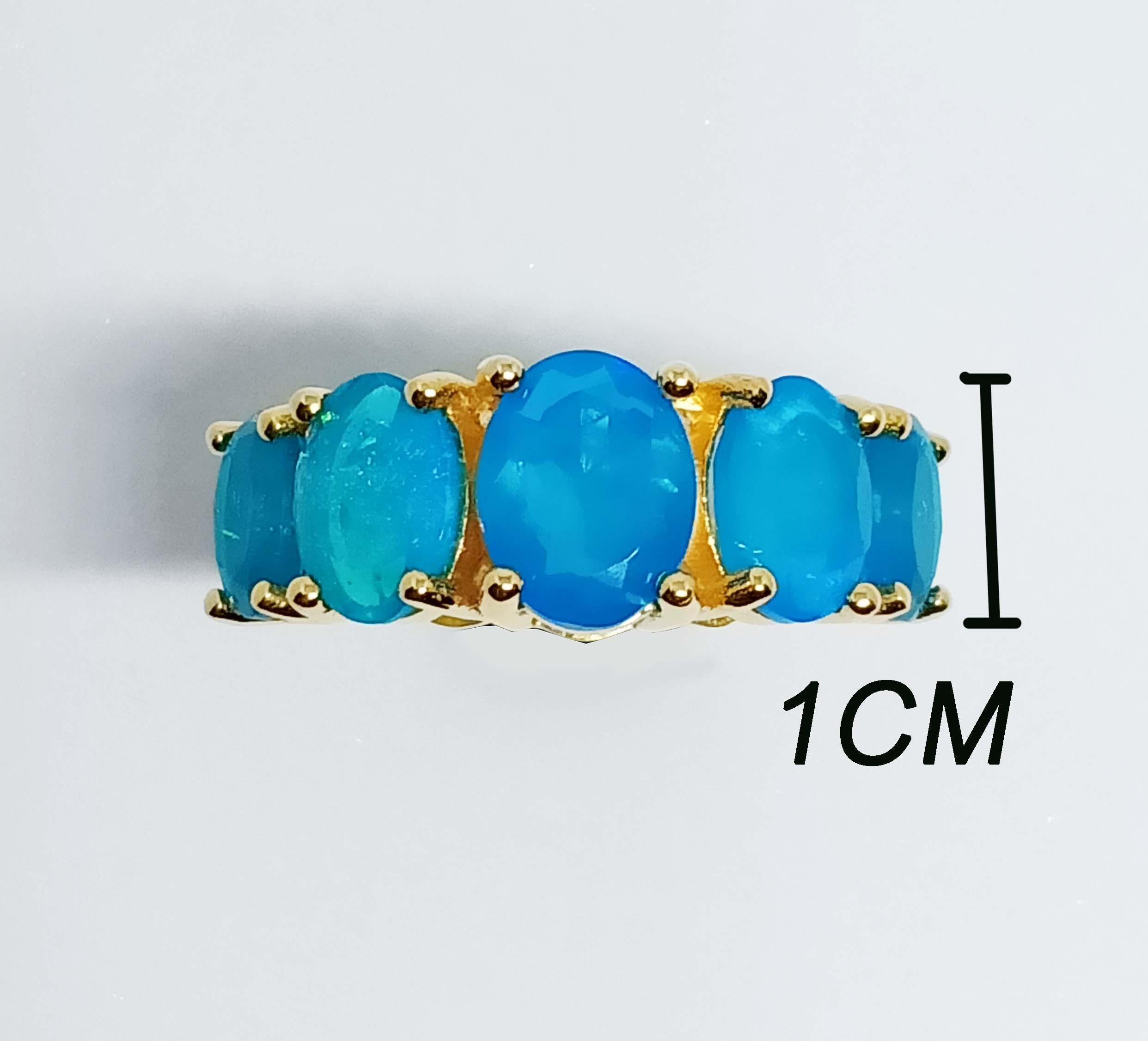 Blue Opal Oval 9x7 mm 1 pc.
Blue Opal Oval 8x6 mm. 2 pcs.
Blue Opal Oval 7x5 mm. 2 pcs.
All total 4.90 cts.
Sterling Silver in 18K Gold Plated.
Size ring 7 us.

