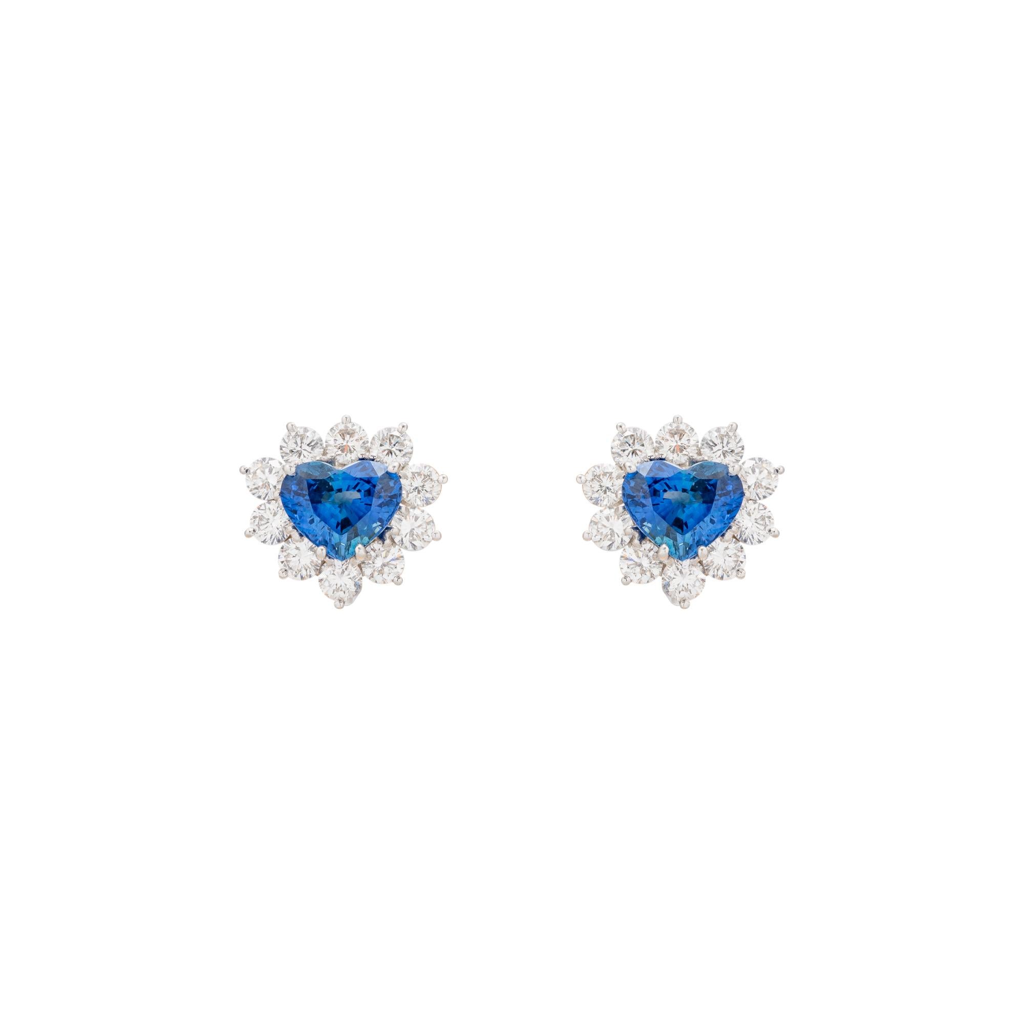 Platinum Heart Shaped Sapphire and Diamond earrings featuring two heart shaped earrings with a total weight of 4.91 carats, framed with 10 round brilliant cut diamonds with a total weight 3.66 carats.


