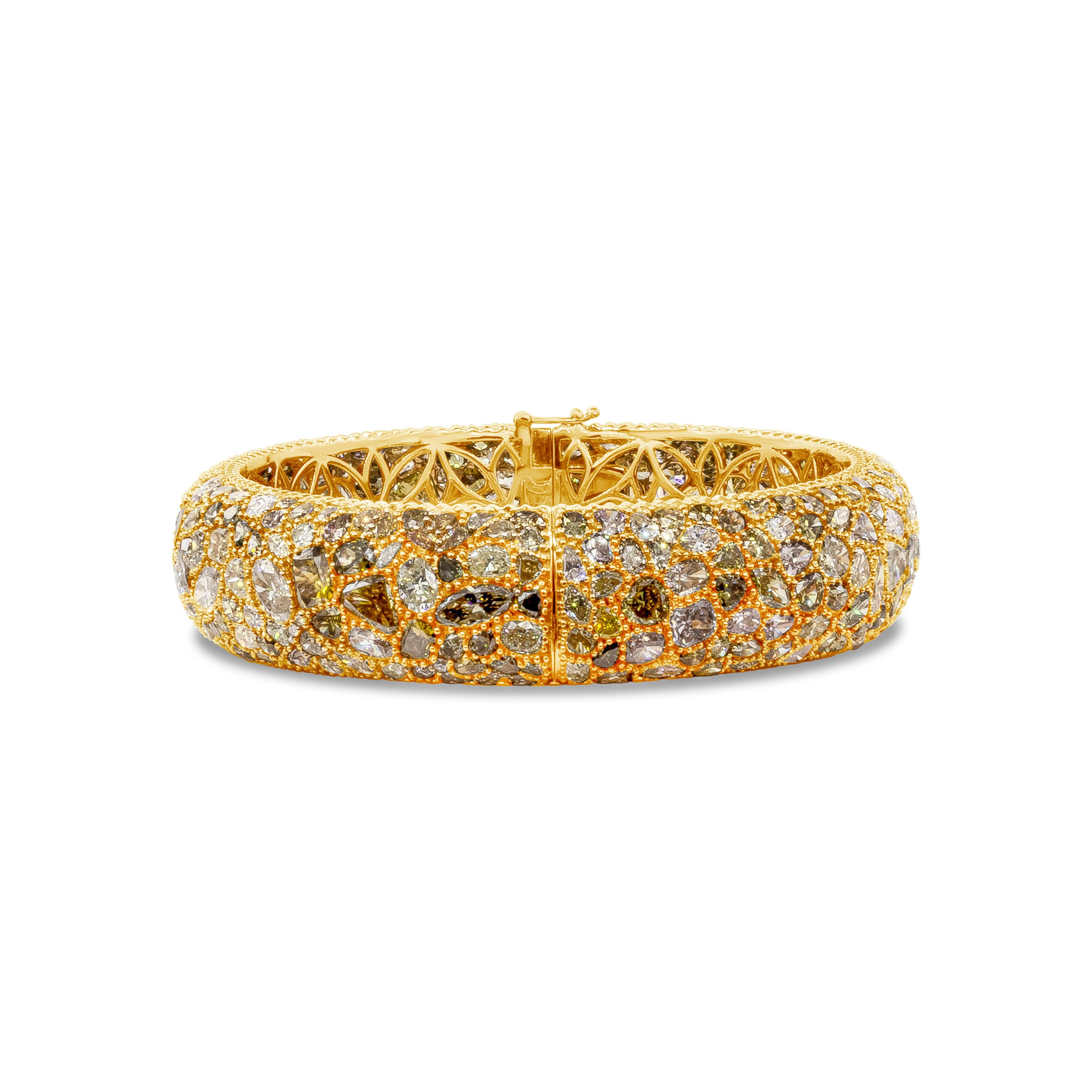 Elegant and color rich domed bangle bracelet showcasing perfectly matched 362 pieces of mixed cut fancy color diamonds, micro-pave on an 18k rose gold setting, weighing 49.12 carat total. Each diamond is uniquely cut to fit seamlessly and cohesively.