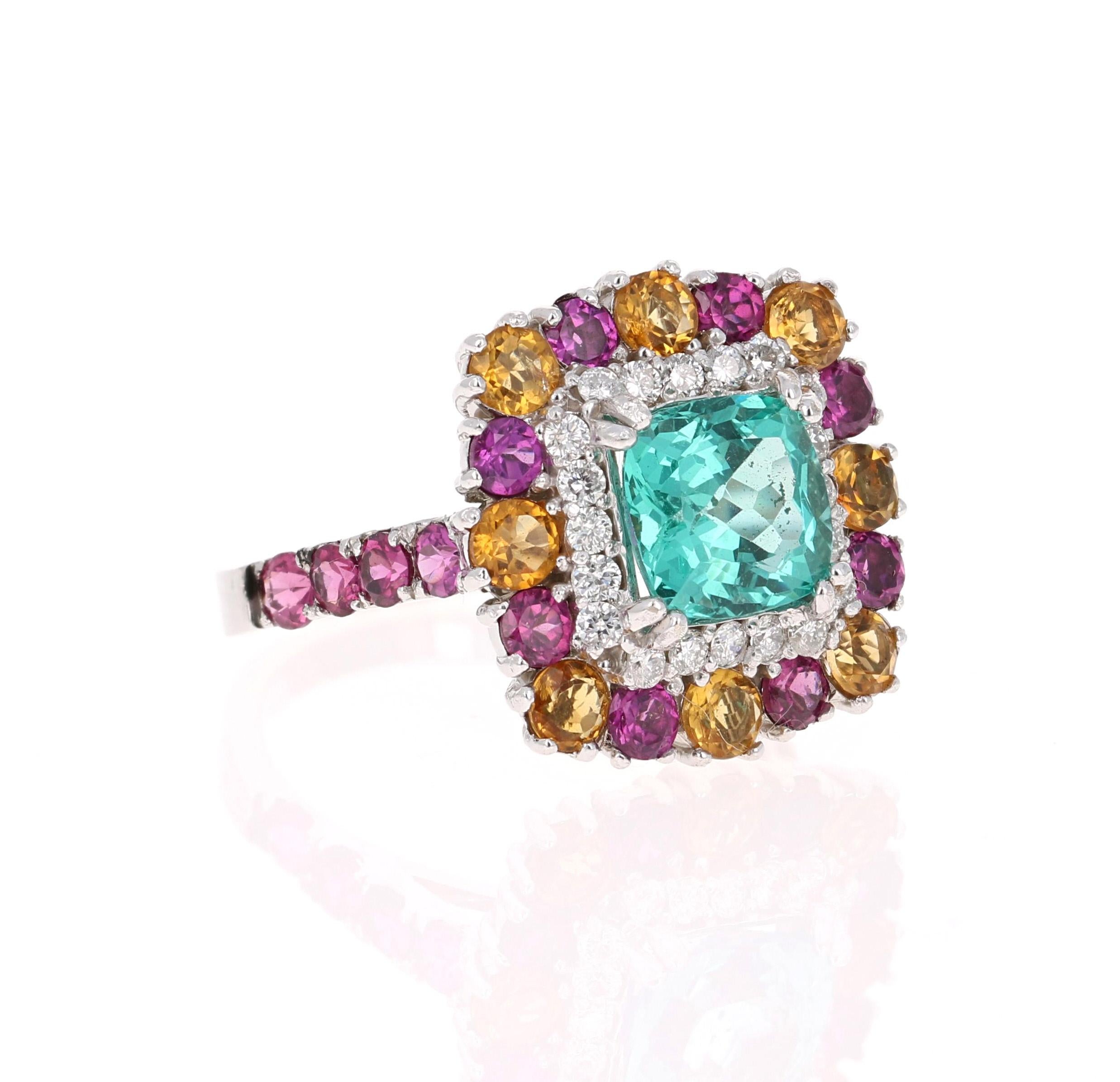 Gorgeous  Apatite, Purple Garnet, Citrine and Diamond Ring.  
This ring has a 2.07 Carat Cushion Cut Apatite in the center of the ring and is surrounded by 20 Round Cut Diamonds that weigh 0.33 carats (Clarity: SI, Color: F).  It is also embellished