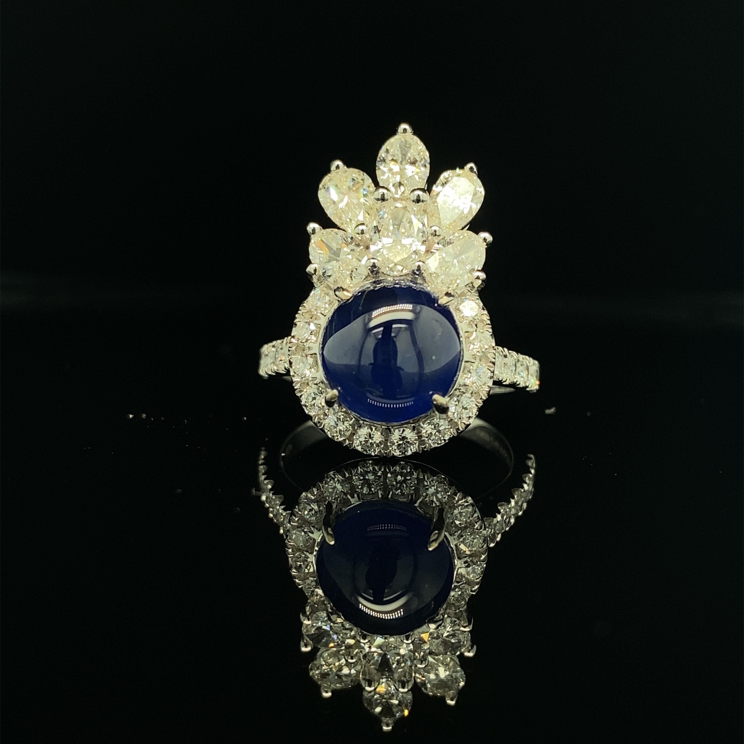 4.92 Carat GIA Certified Burma No Heat Sapphire and White Diamond Cocktail Ring:

A beautiful ring, it features a gorgeous GIA certified natural Burmese blue sapphire cabochon weighing 4.92 carat, surrounded by a halo of white round brilliant-cut