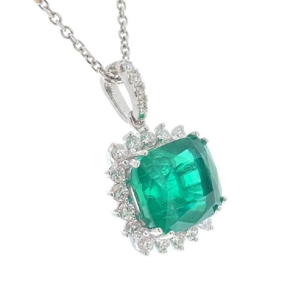 This captivating pendant features a 4.92-carat green cushion emerald, known for its rich, vibrant color and exceptional clarity. The emerald is beautifully enhanced by 22 round diamonds, with a total weight of 0.58 carats, which add a dazzling touch