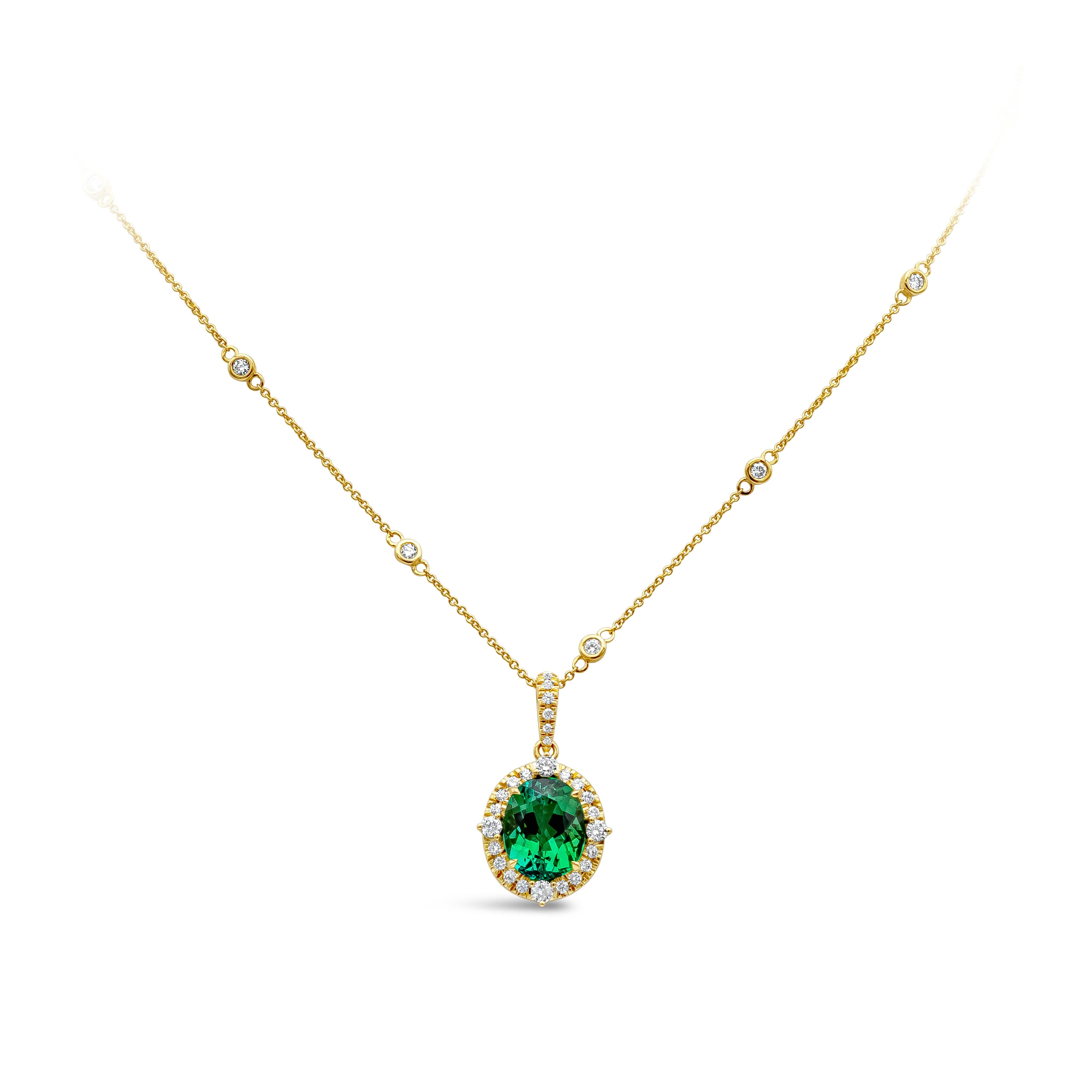 A fashionable pendant necklace showcasing an oval cut green tourmaline weighing 4.92 carat. Center stone is accented with bright round diamonds weighing 0.96 carats total, F/G color and VS clarity. Chain has 0.50 carats total brilliant round