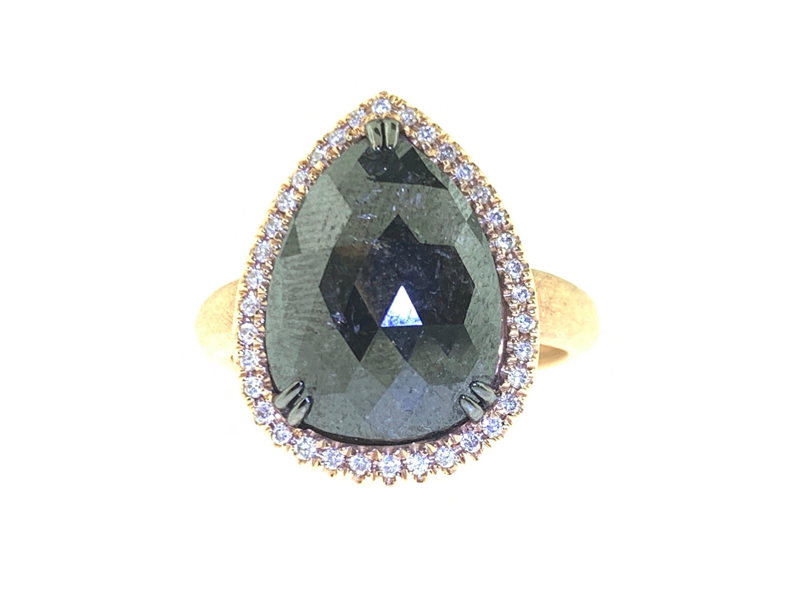 This stunning cocktail ring features a beautiful 4.92 Carat Pear Shape Rose Cut Black Diamond with a Diamond Halo. This Ring is set in 18k Rose Gold. Total Diamond Weight (not including center stone) = 0.14 Carats. Ring Size is 6 1/2.
