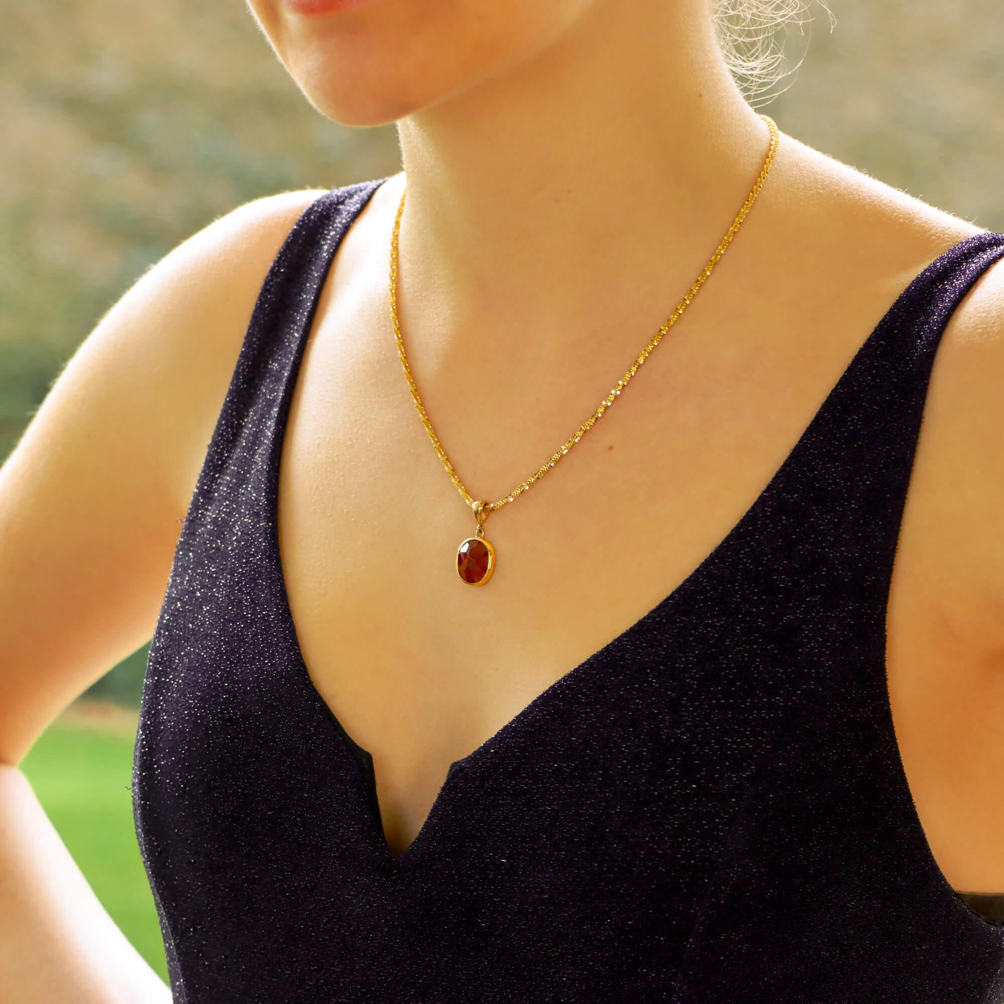A simple yet elegant round garnet pendant set in 9k yellow gold.

The pendant is set with a lovely 4.92ct red garnet. Due to the depth of the garnet the colour is a subtle shade and isn’t too vibrant so catches the light beautifully once around the