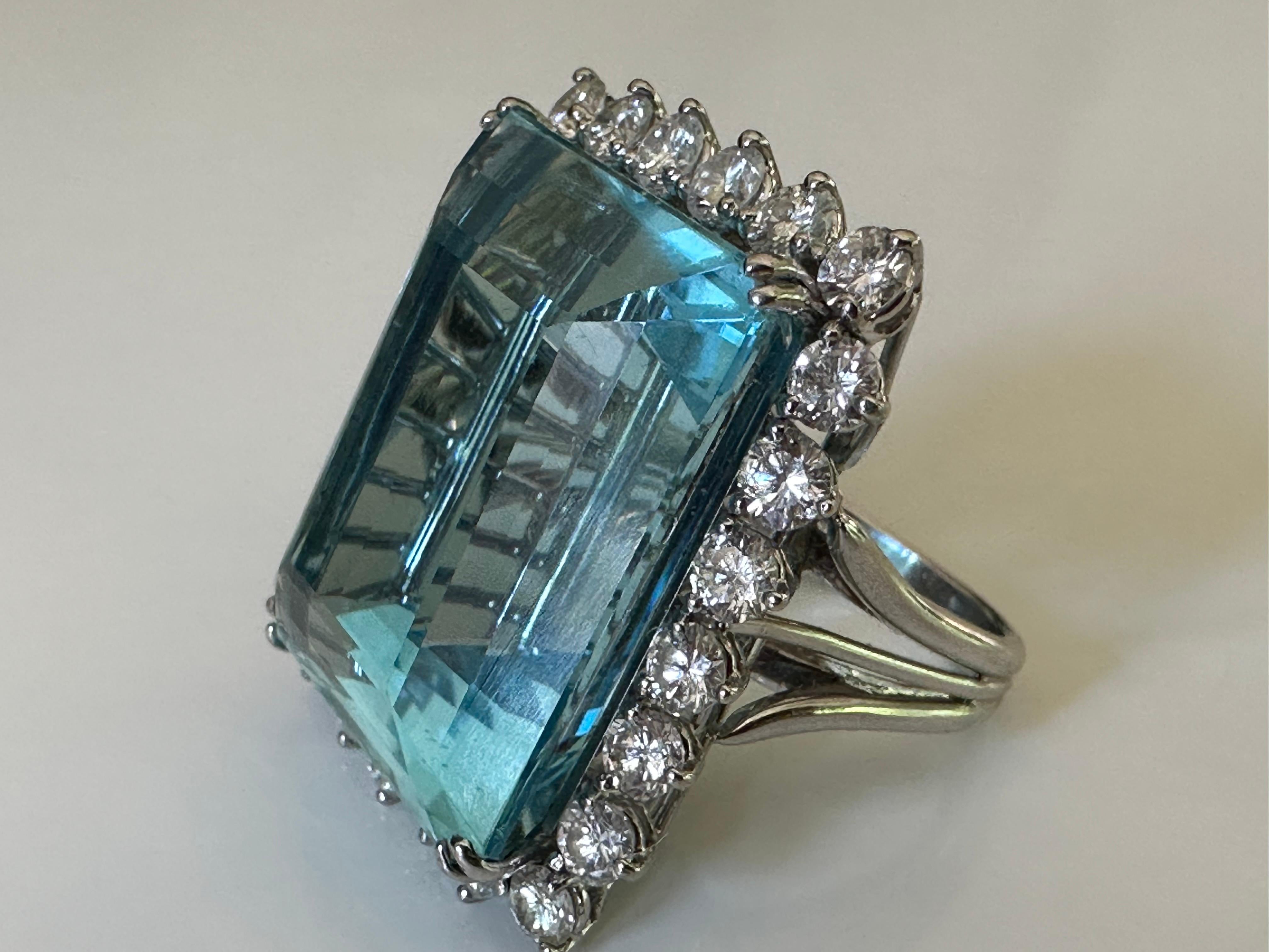 With its stunning hue, reminiscent of the clear blue ocean, this monumental 49.20-carat emerald-cut aquamarine centers this magnificent cocktail ring. Designated as 