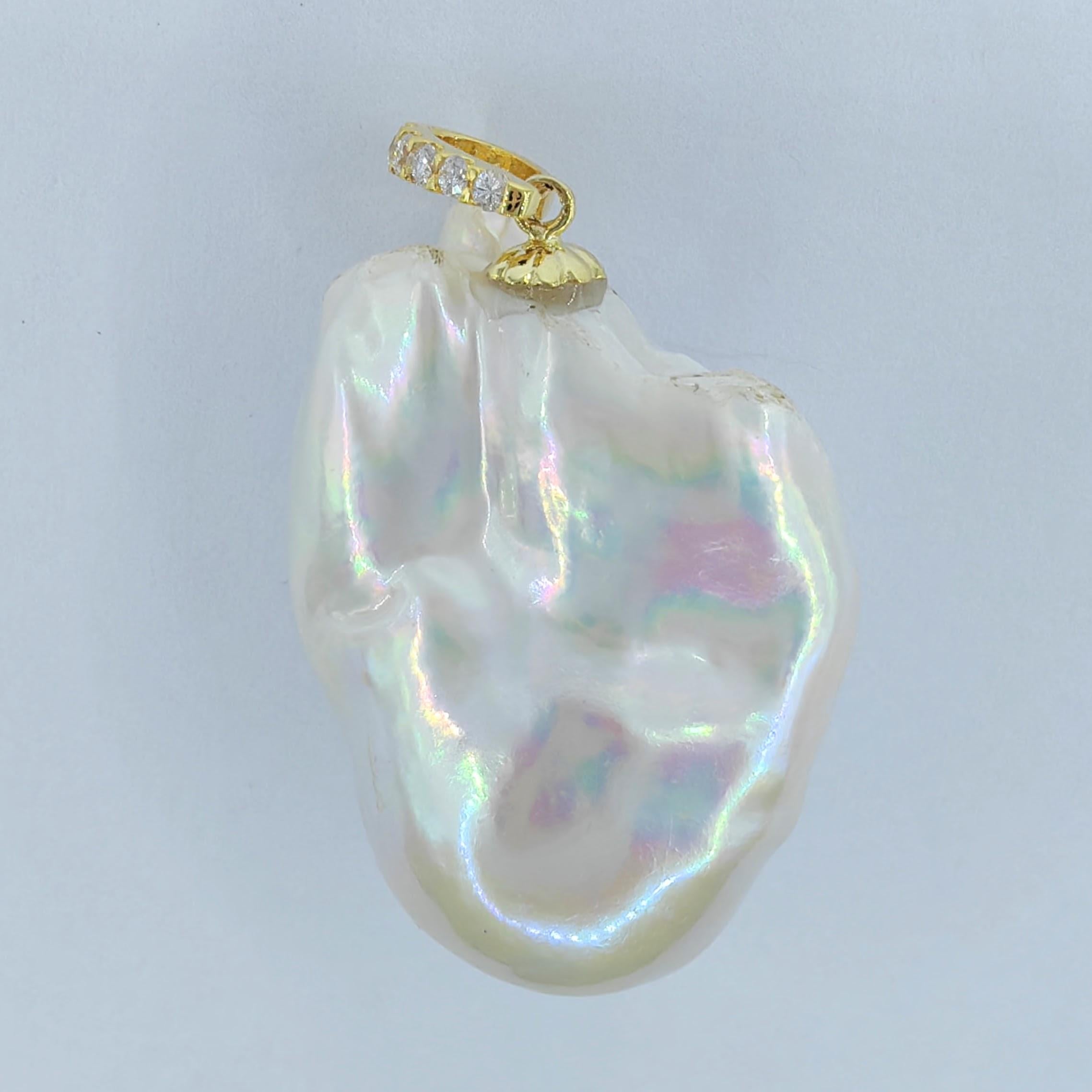Introducing our mesmerizing 49.24ct Large Iridescent Baroque Pearl Diamond Pendant in 18K Yellow Gold. This extraordinary pendant features an extra-large Freshwater Baroque Pearl, boasting an impressive weight of 49.24 carats. Its organic and