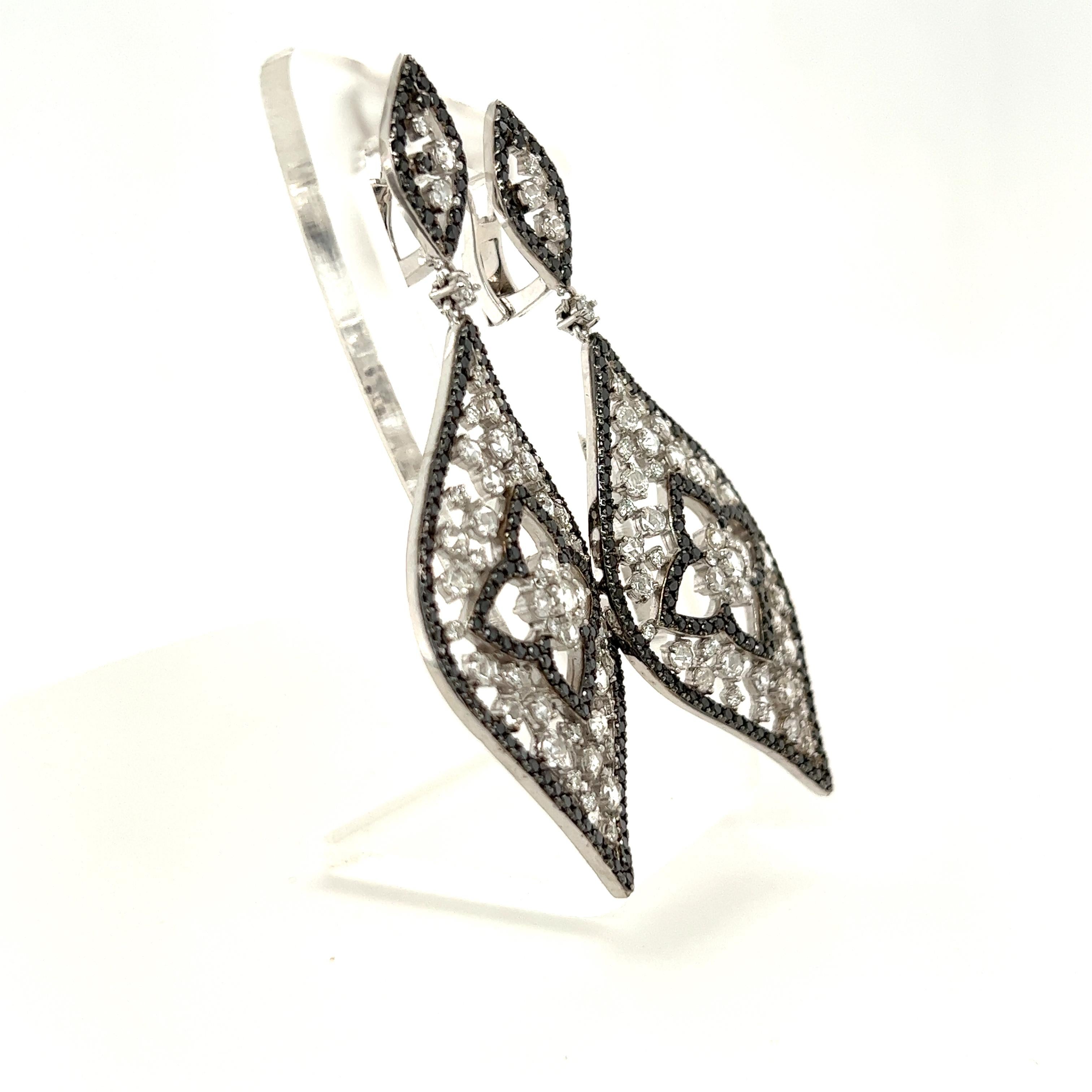 These earrings have Natural Round Cut Black Diamonds that weigh 2.33 carats and Natural Rose Cut White Diamonds that weigh 2.15 carats. The Clarity and Color of the Rose Cut Diamonds are VS-F. It also has Natural Round Brilliant Cut White Diamonds